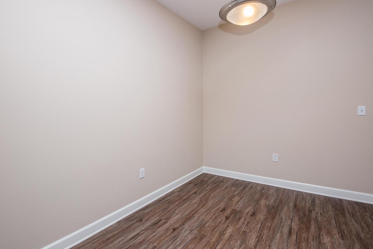 a bedroom with a wooden floor