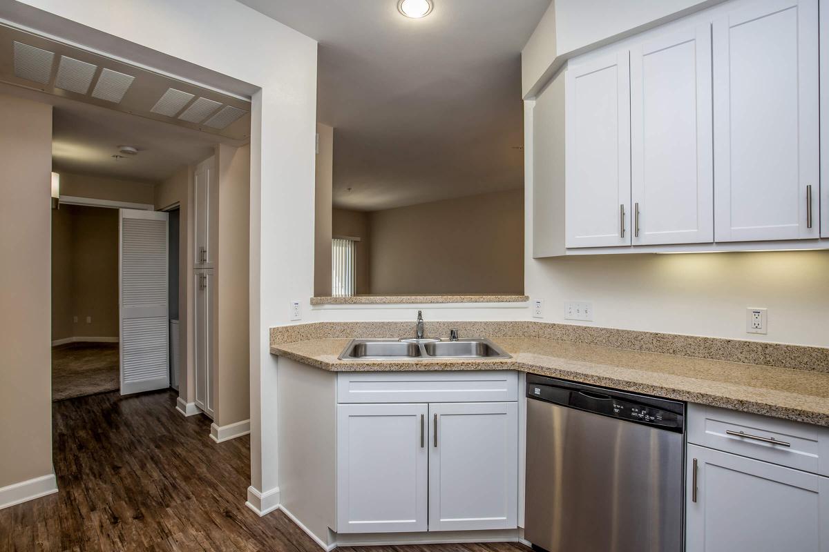 a kitchen with a sink and a mirror