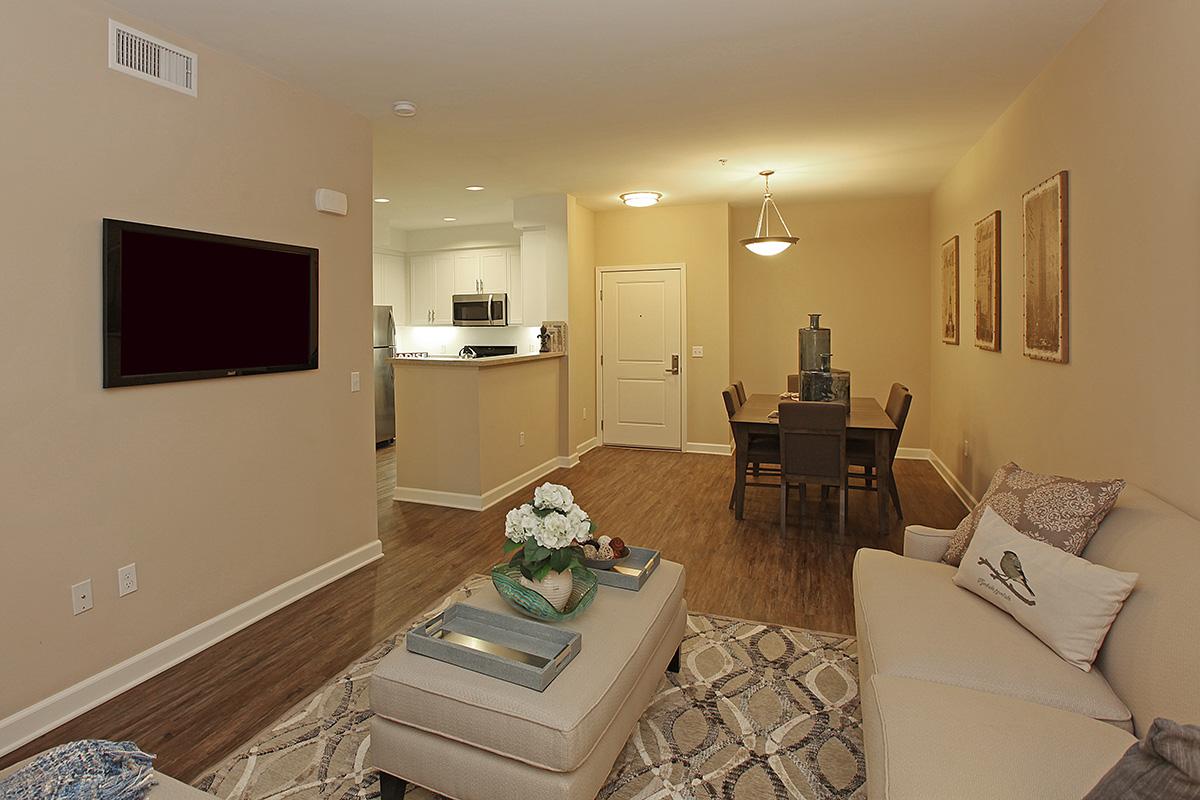 a living room filled with furniture and a mirror