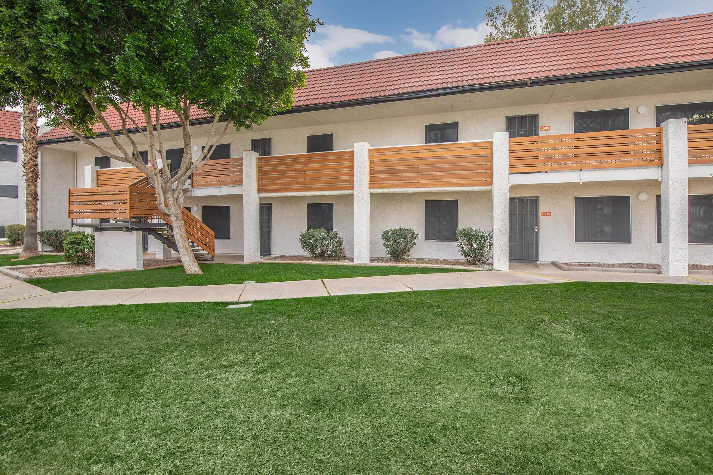 a house with a lawn in front of a building