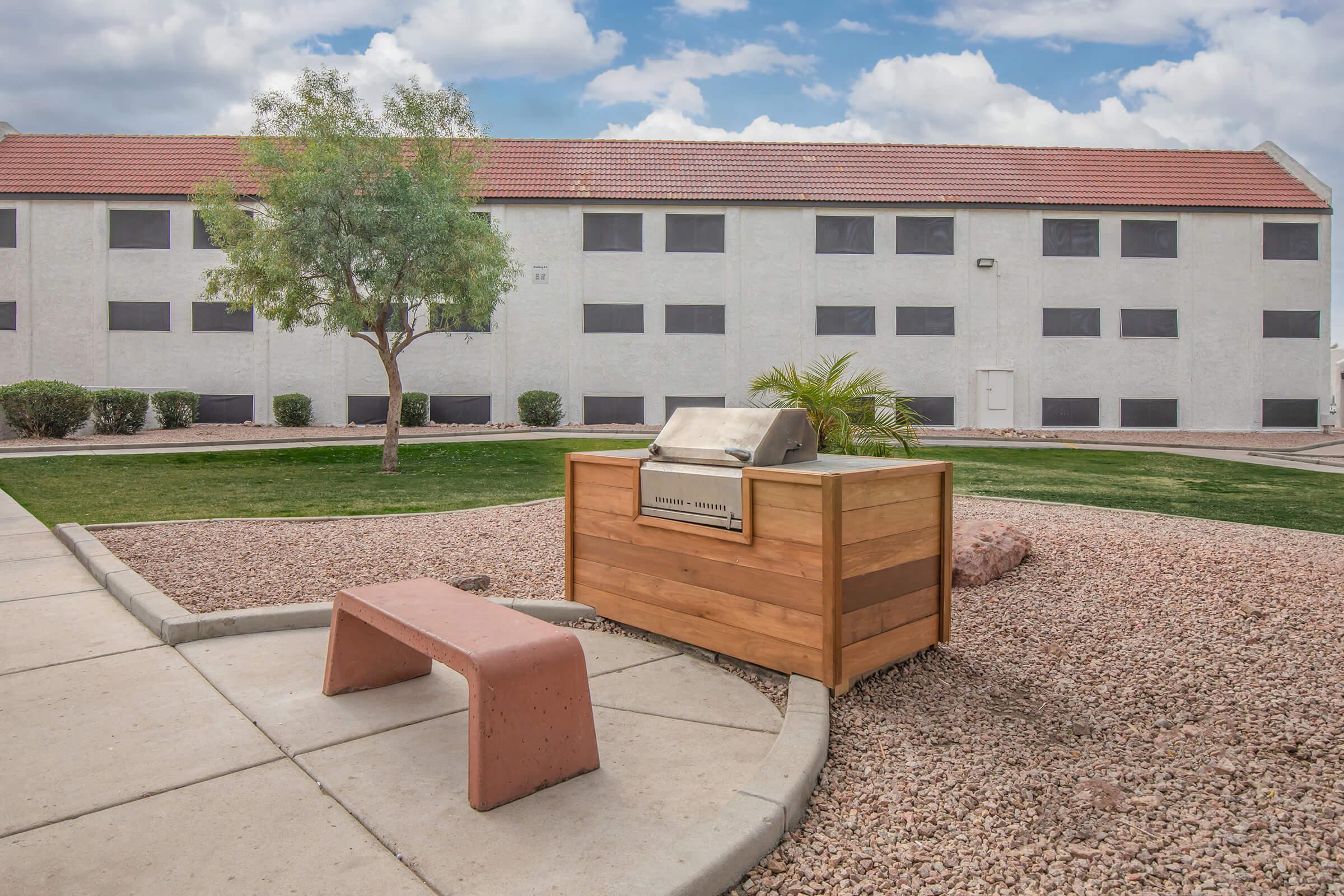 a bench in front of a brick building