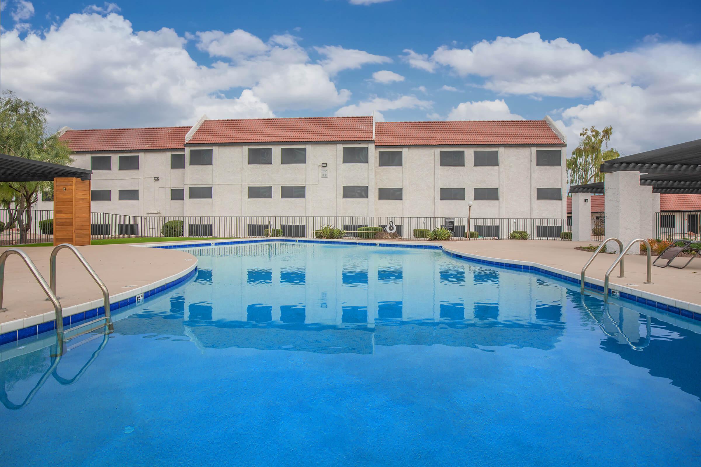 a blue pool of water in front of a building