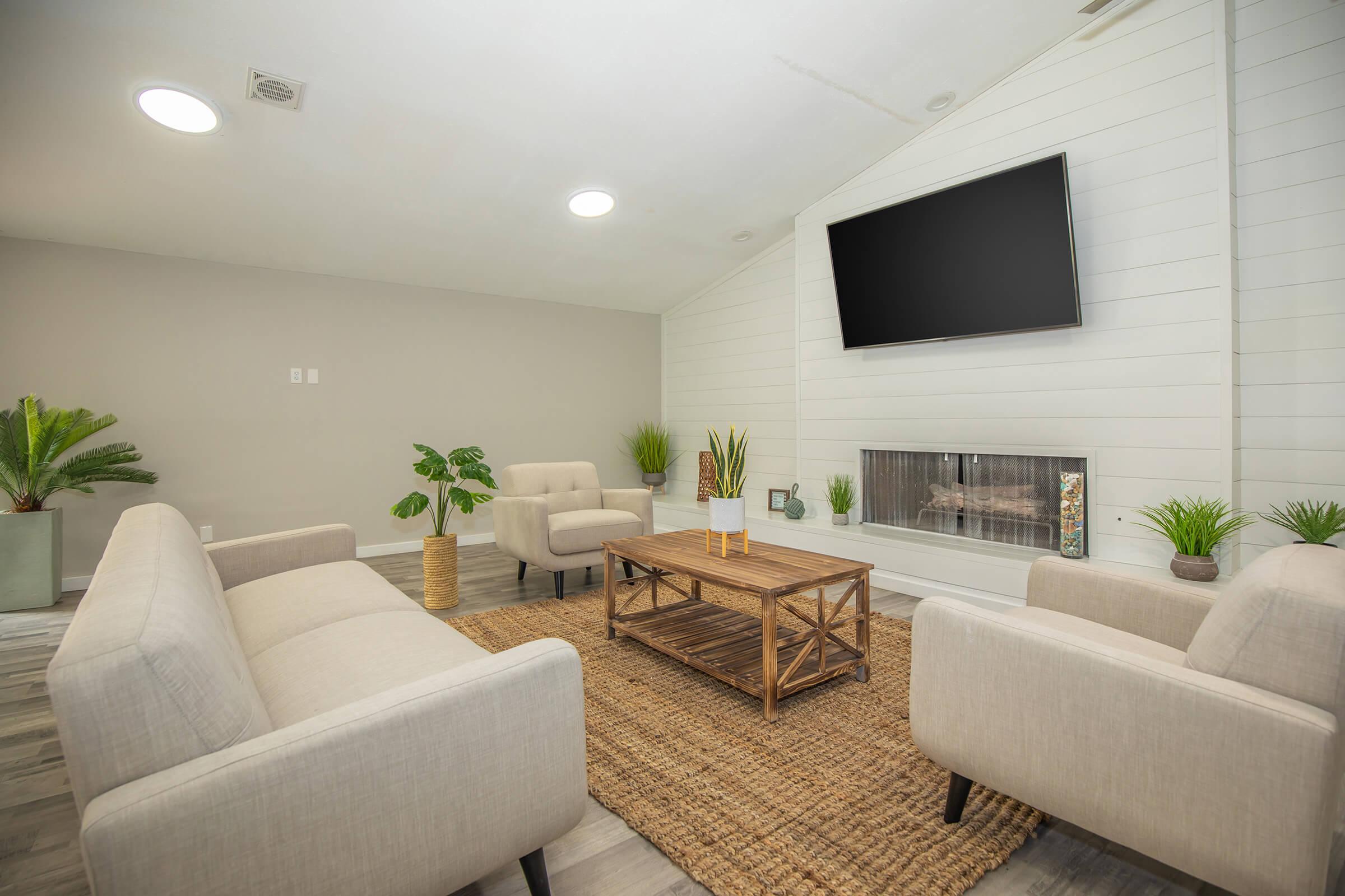 a living room filled with furniture and a large window