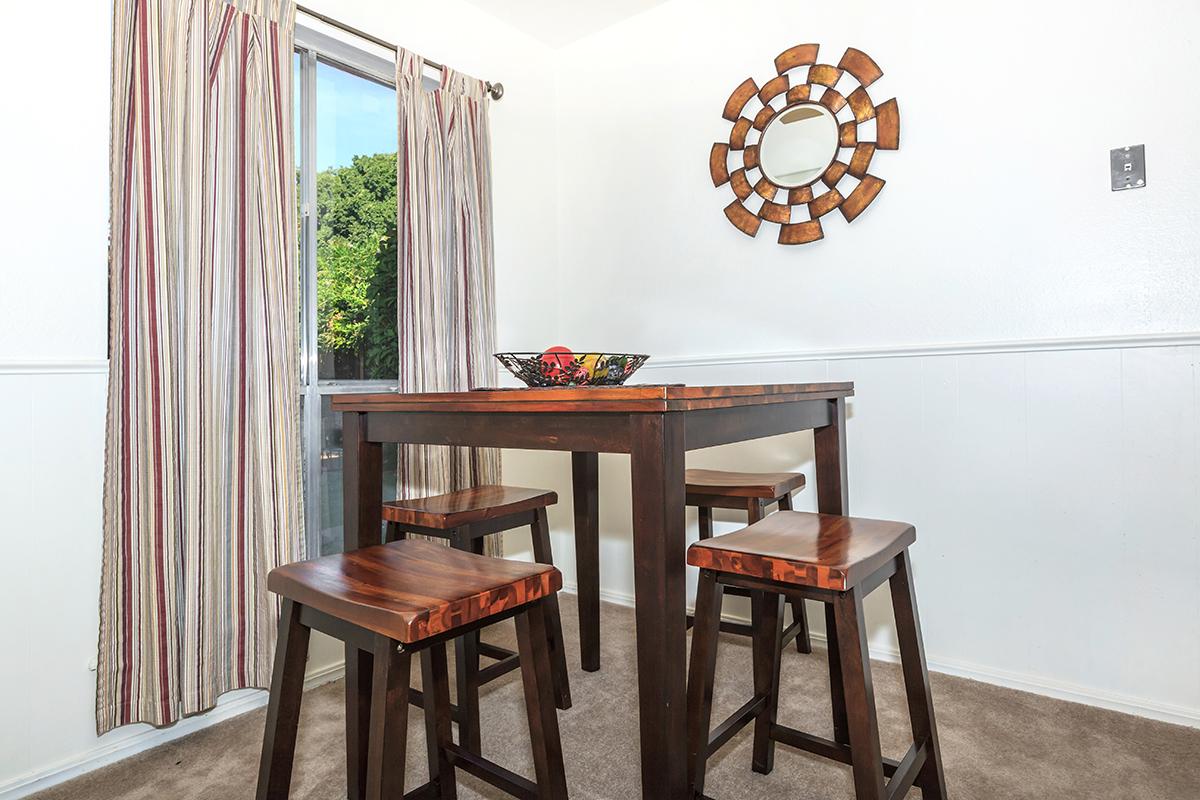 a dining room table in front of a window