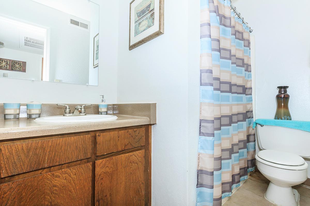 a white sink sitting under a window