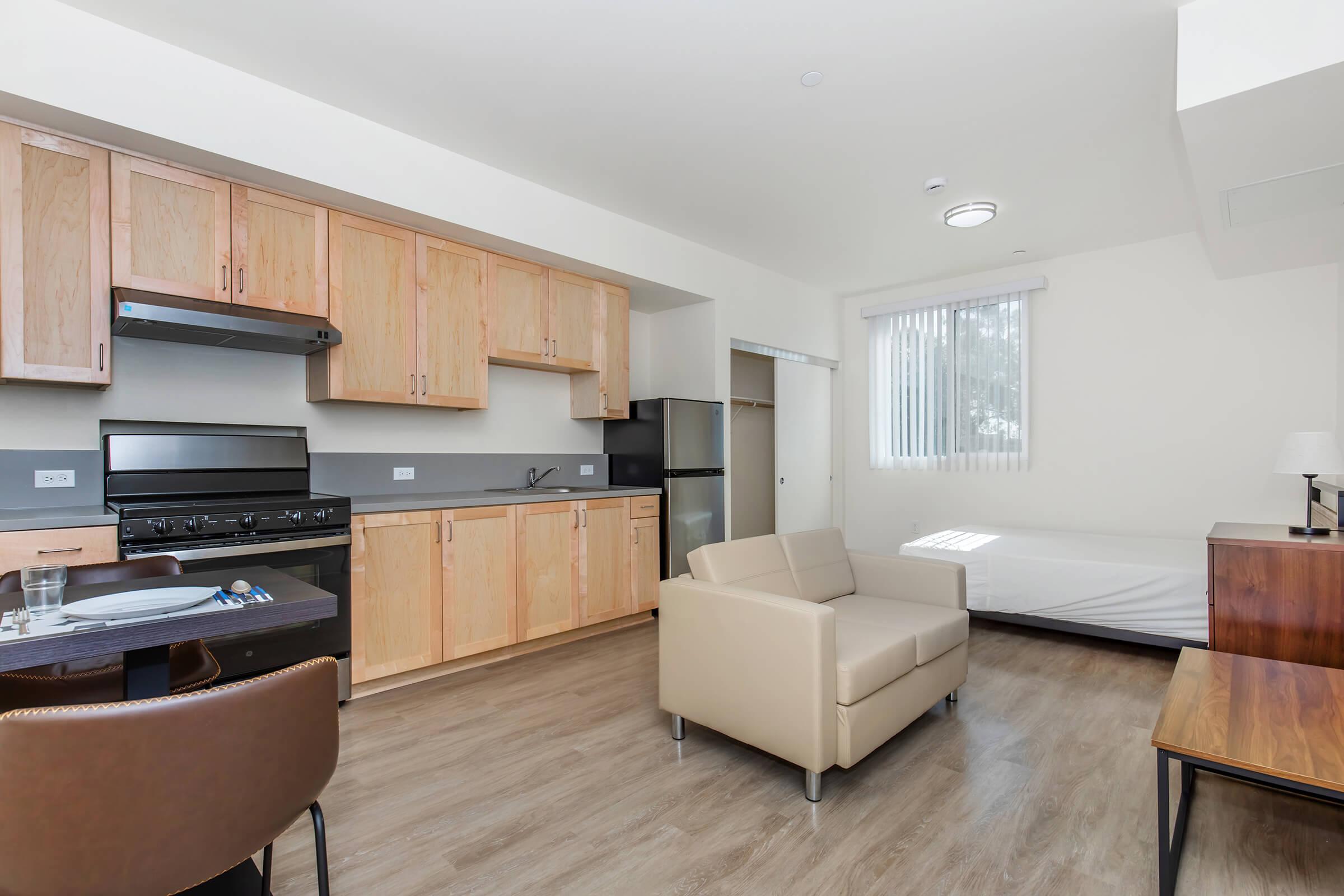 a living room filled with furniture and a large window