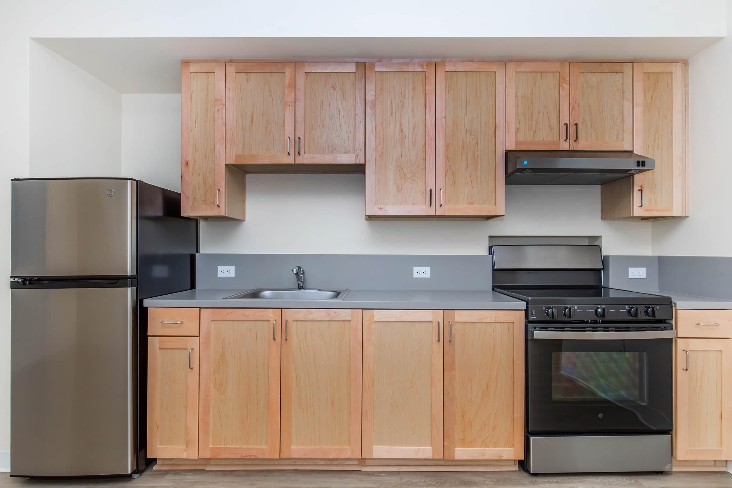 a kitchen with stainless steel appliances and wooden cabinets