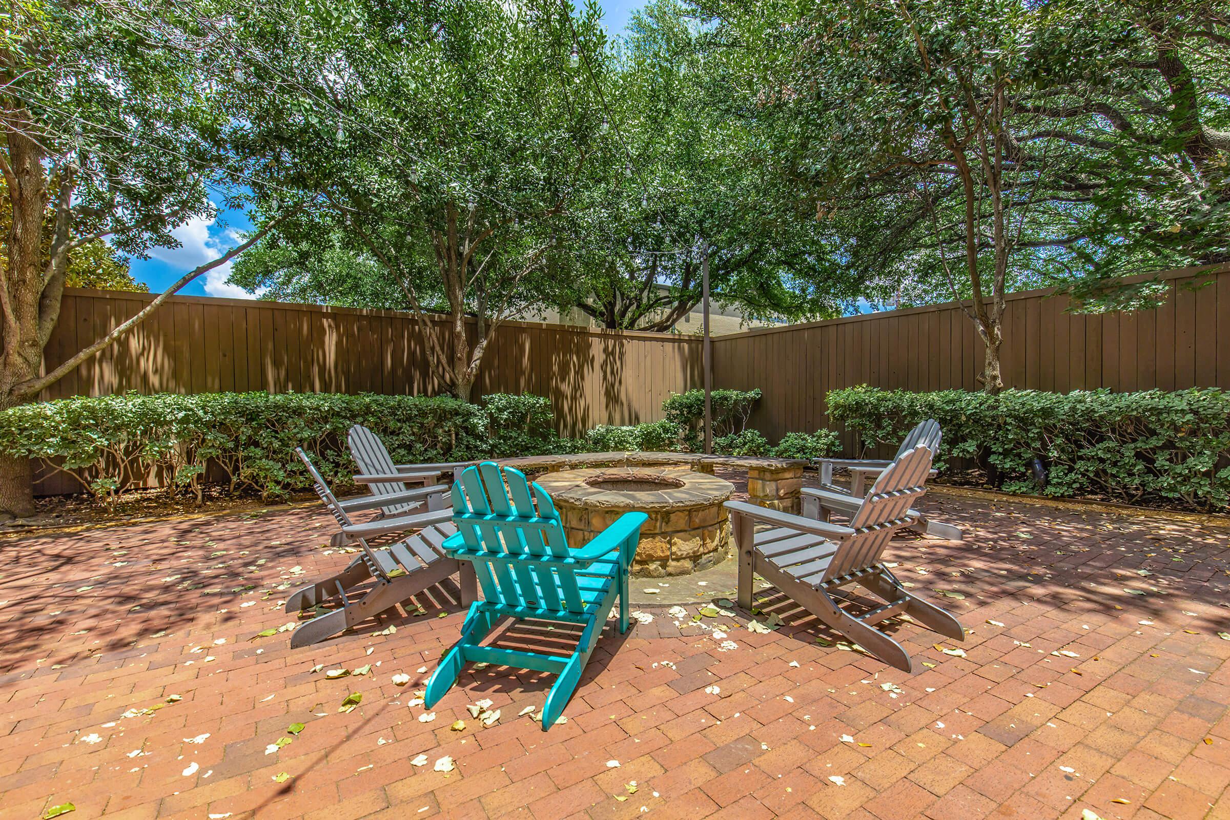 a wooden bench sitting in front of a fence