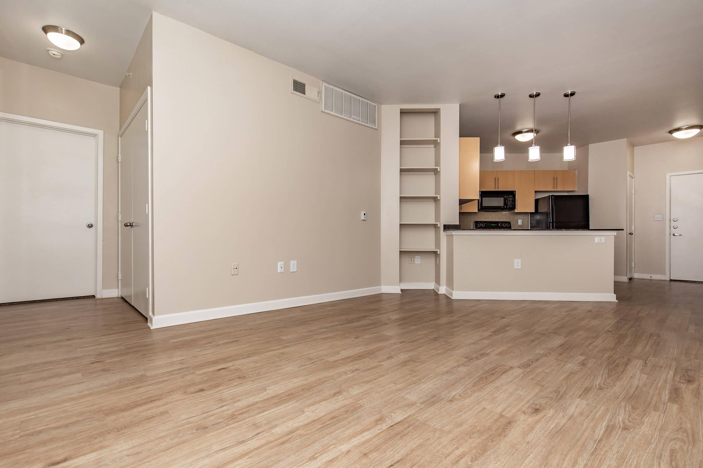 a large empty room with a wood floor