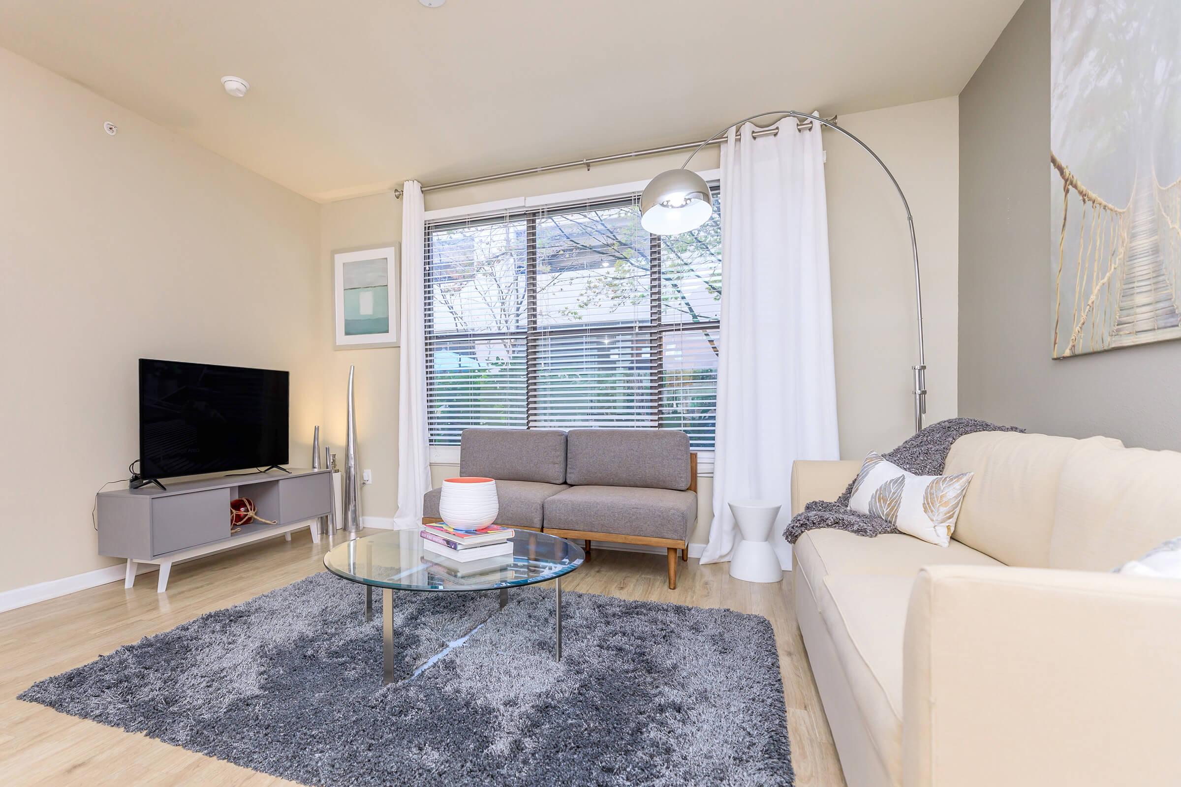 a living room filled with furniture and a flat screen tv