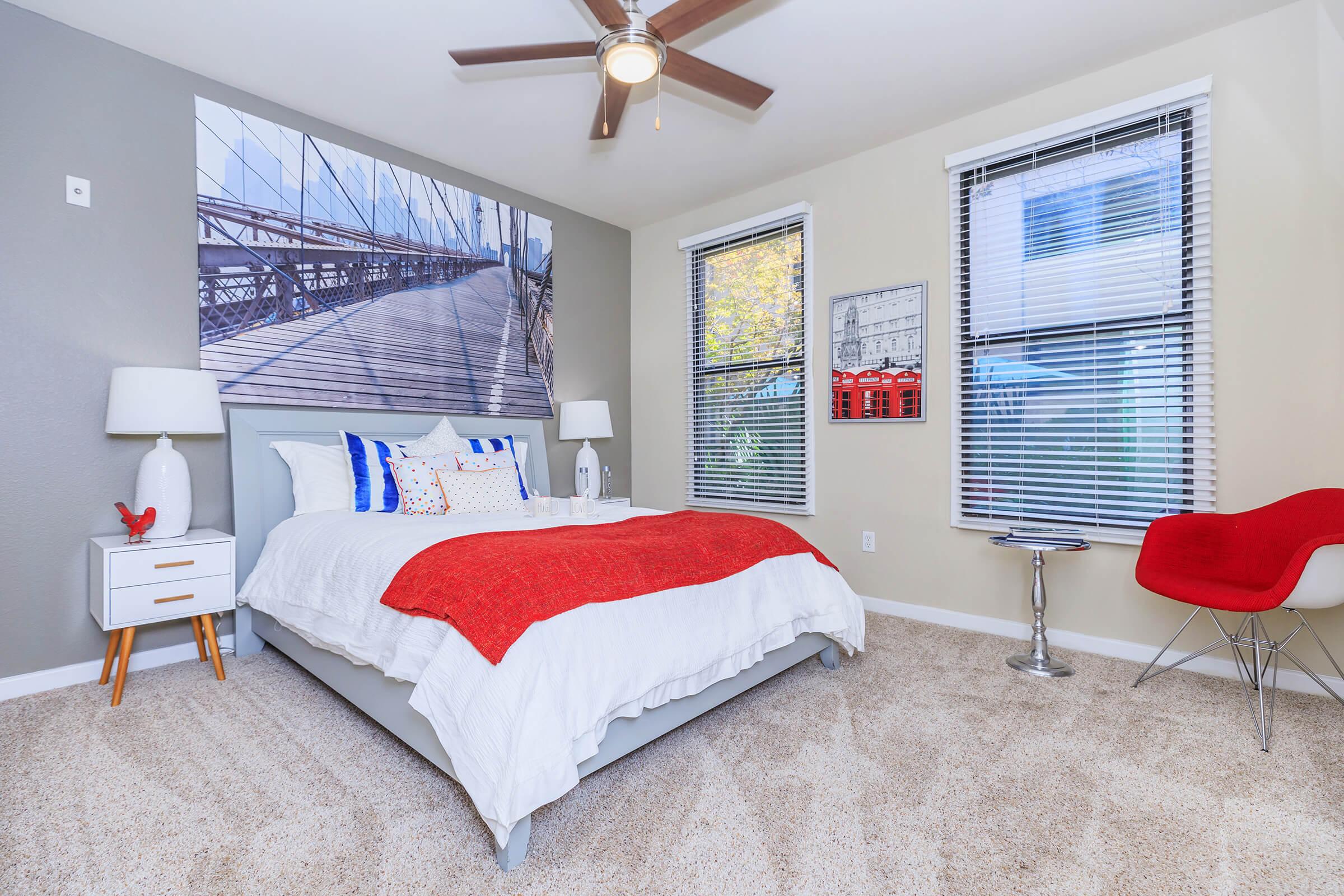 a bedroom with a bed and desk in a room