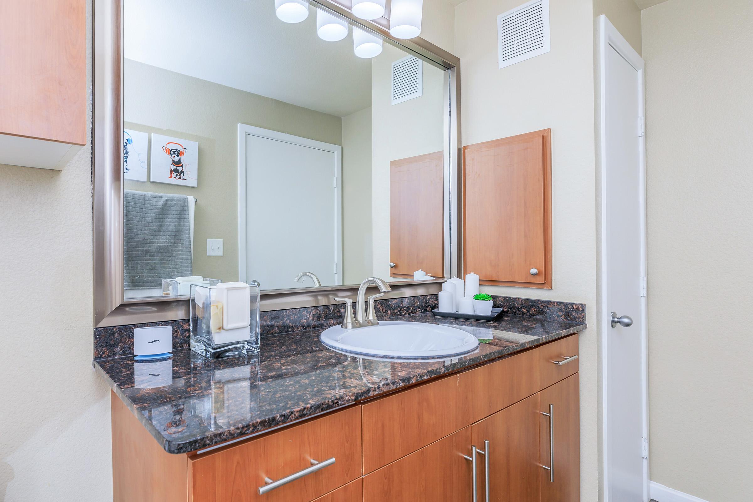 a kitchen with a sink and a mirror