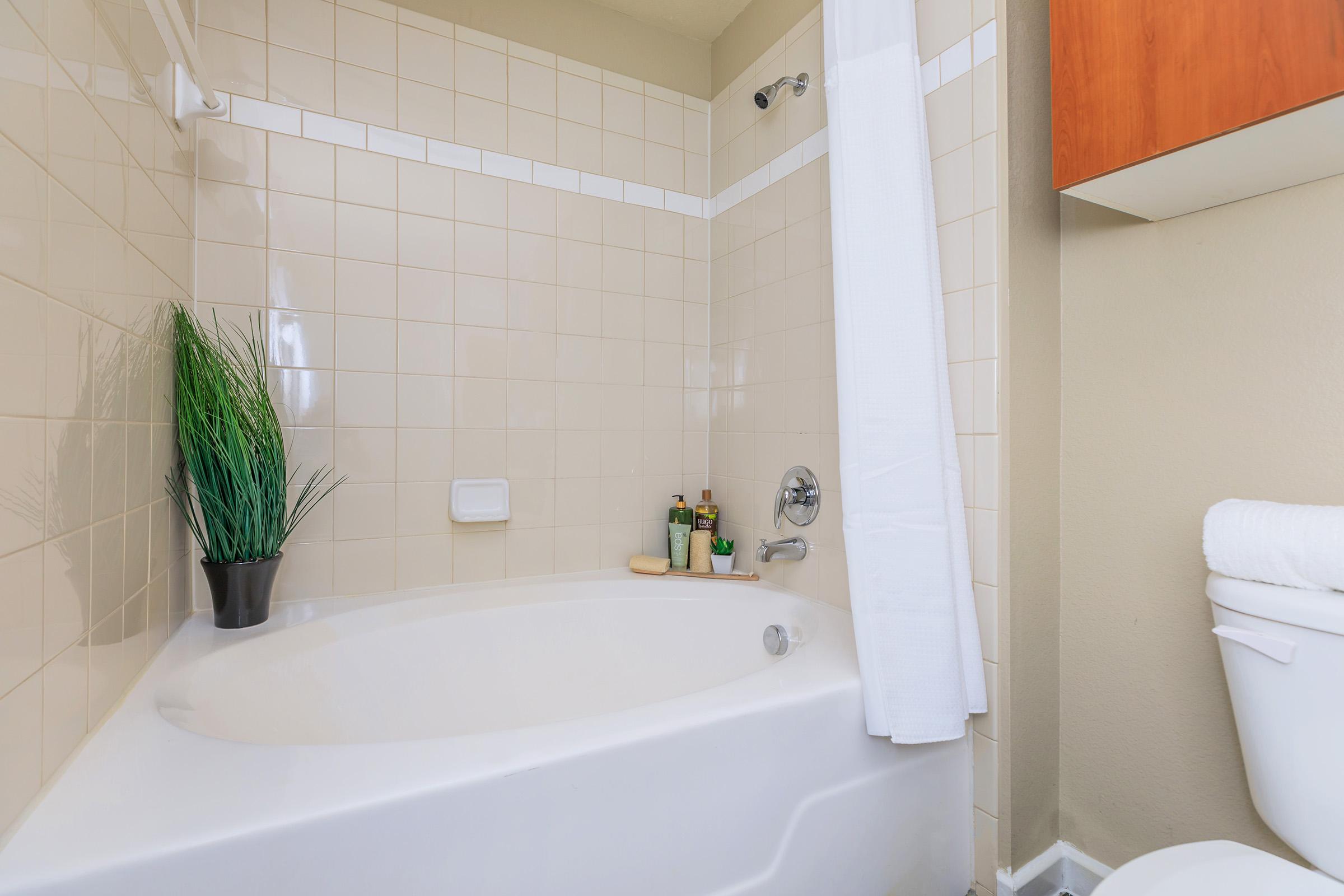 a close up of pink tub and sink