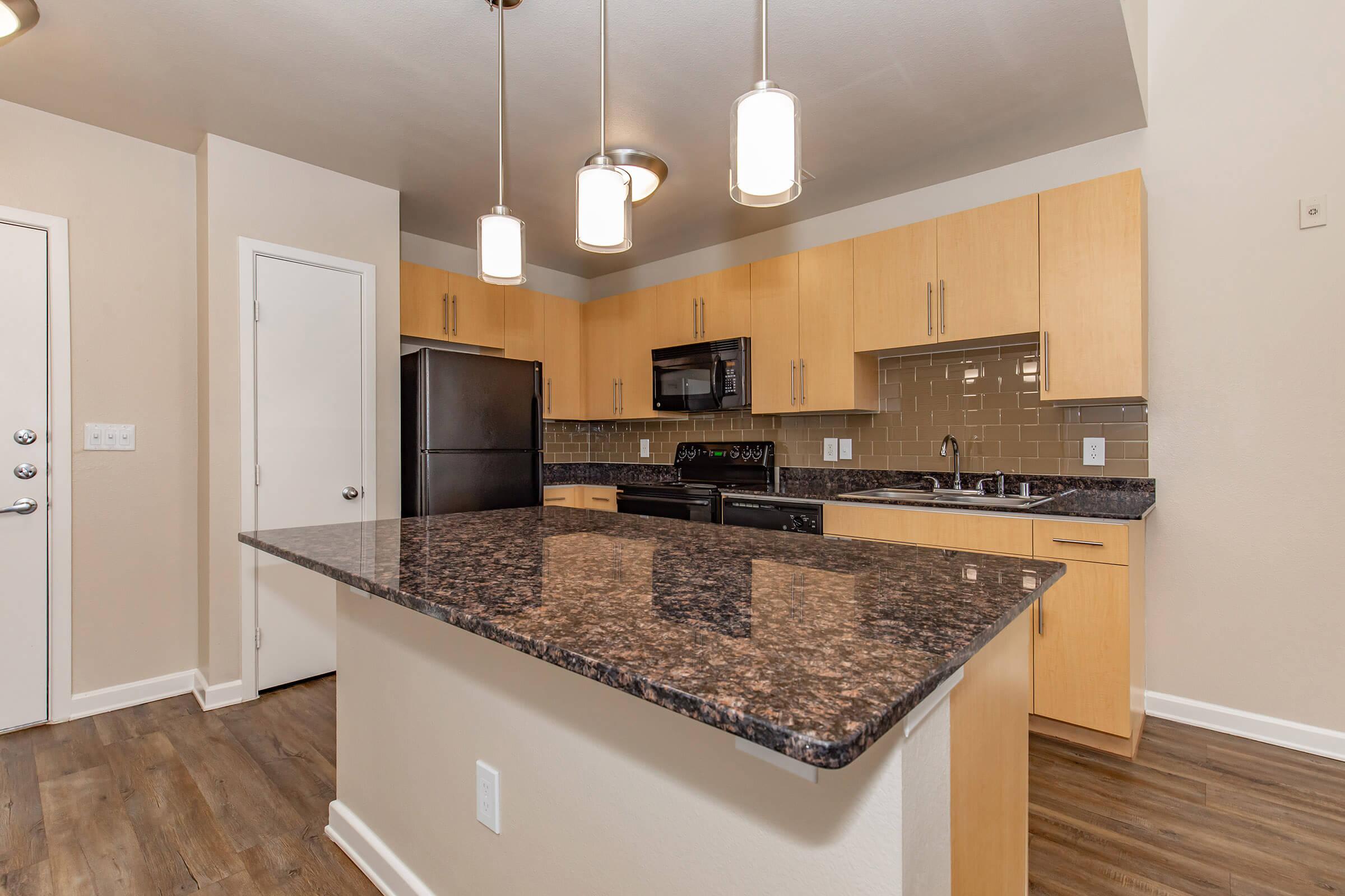 a modern kitchen with stainless steel appliances and wooden cabinets