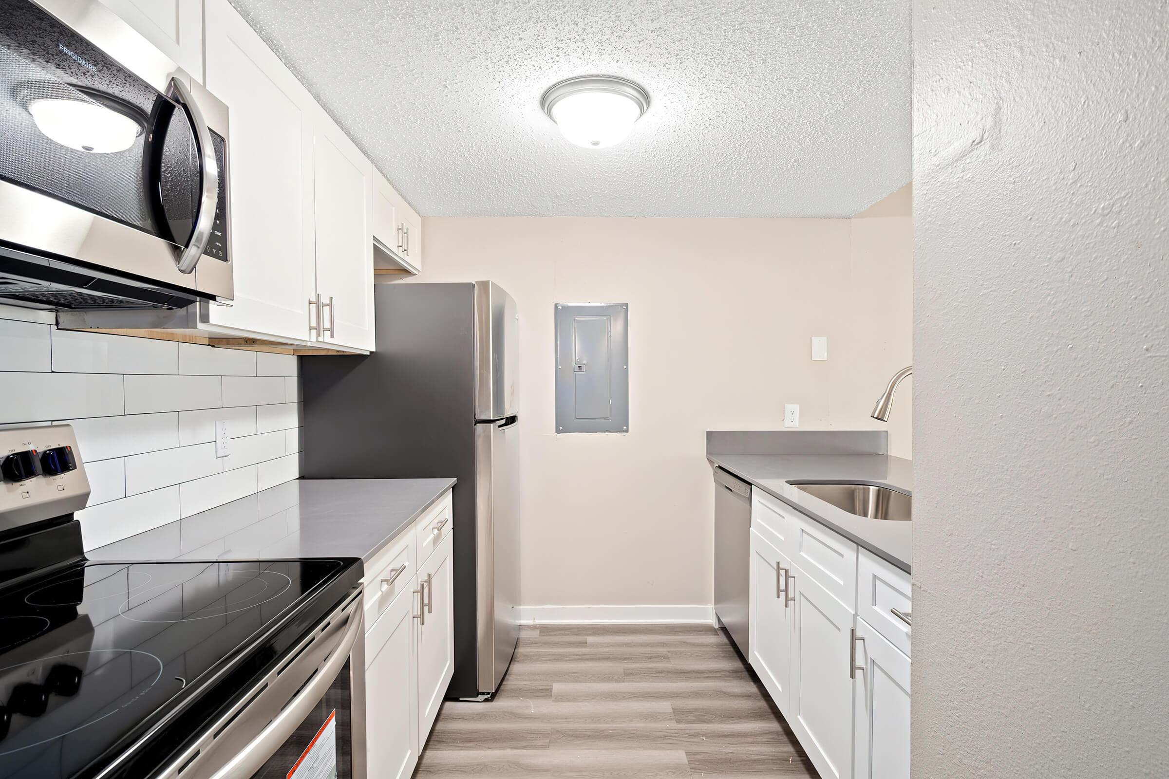 a kitchen with a sink and a mirror