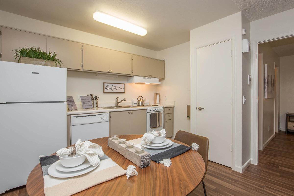 a kitchen with a refrigerator and a table
