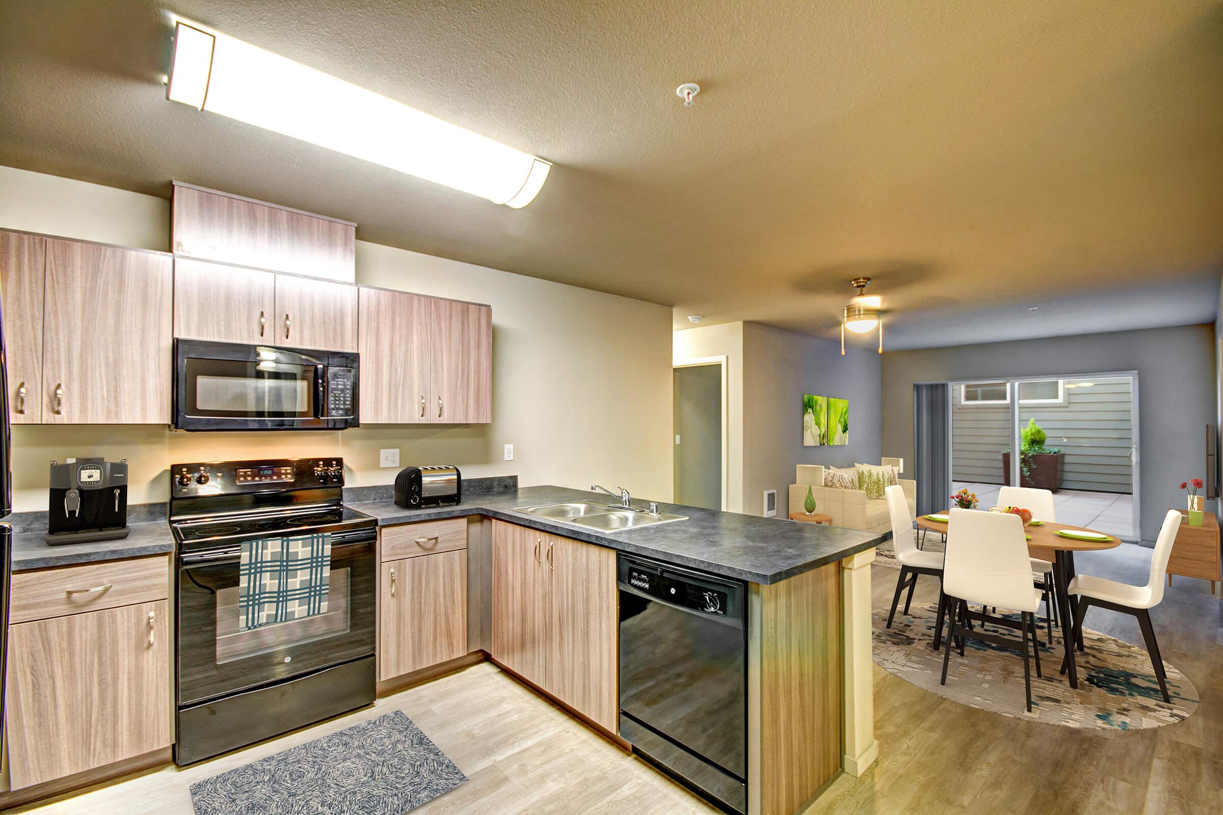 a modern kitchen with stainless steel appliances and wooden cabinets