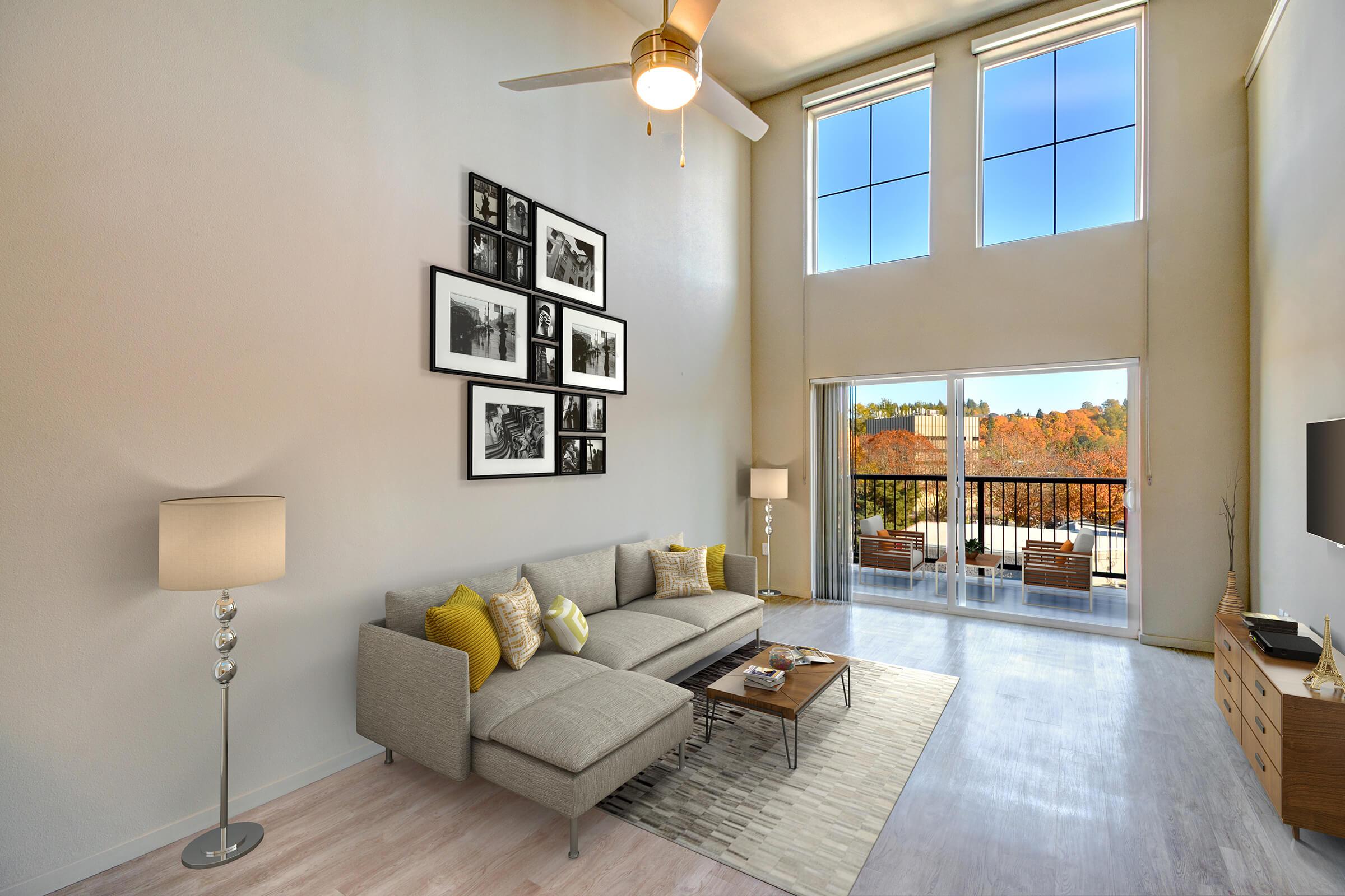 a living room filled with furniture and a large window