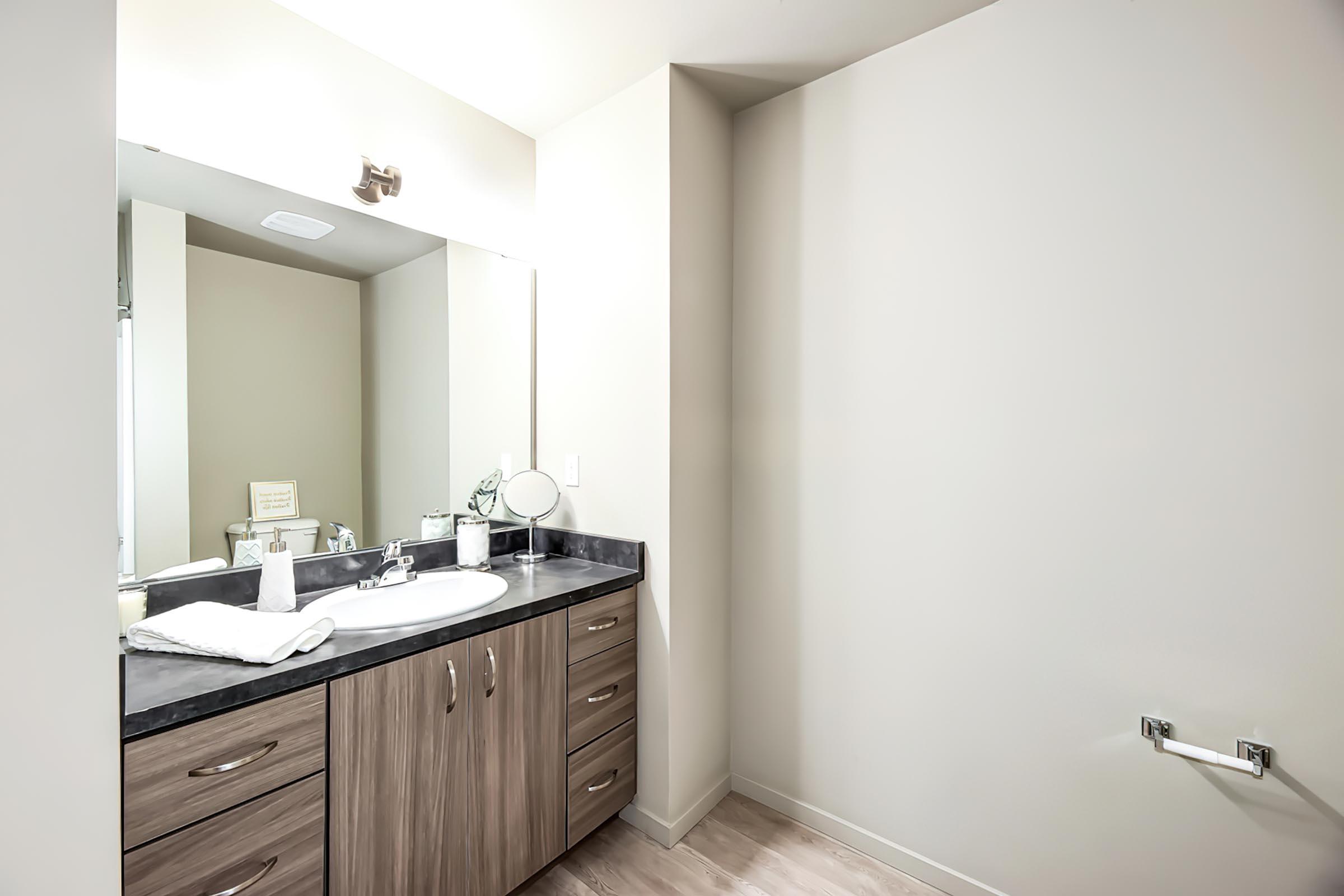 a kitchen with a sink and a mirror