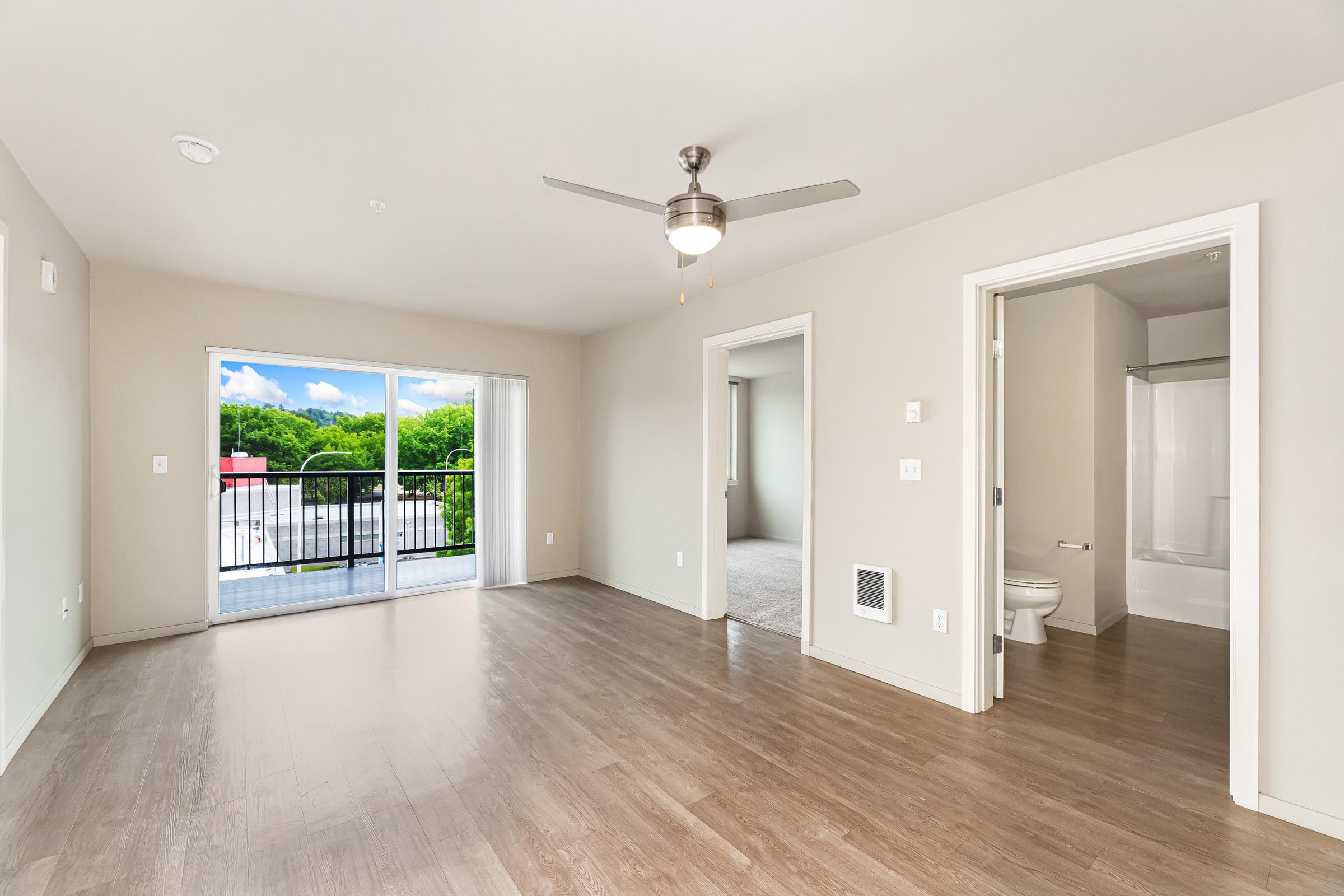 a large empty room with a sink and a mirror