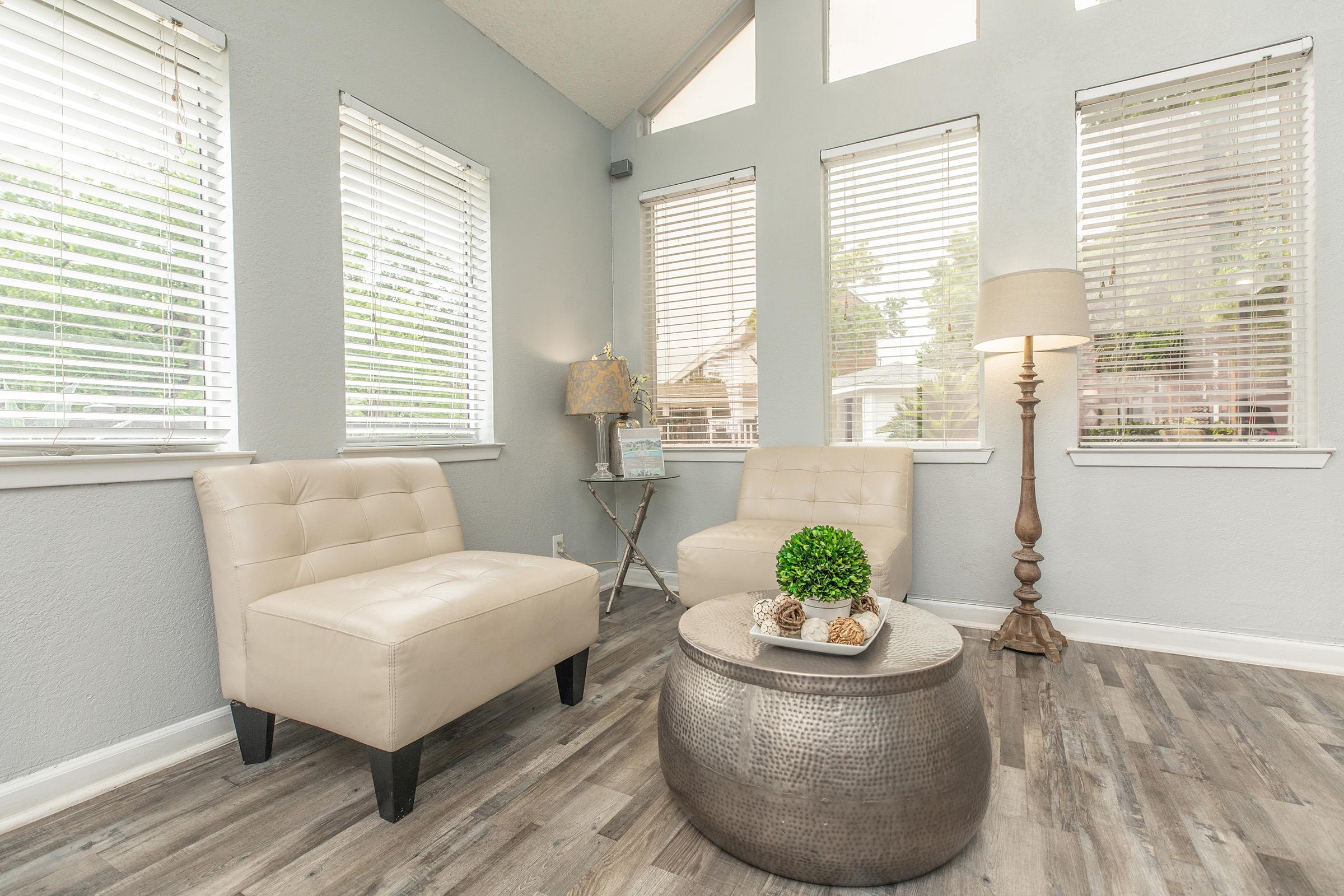 a room filled with furniture and a large window