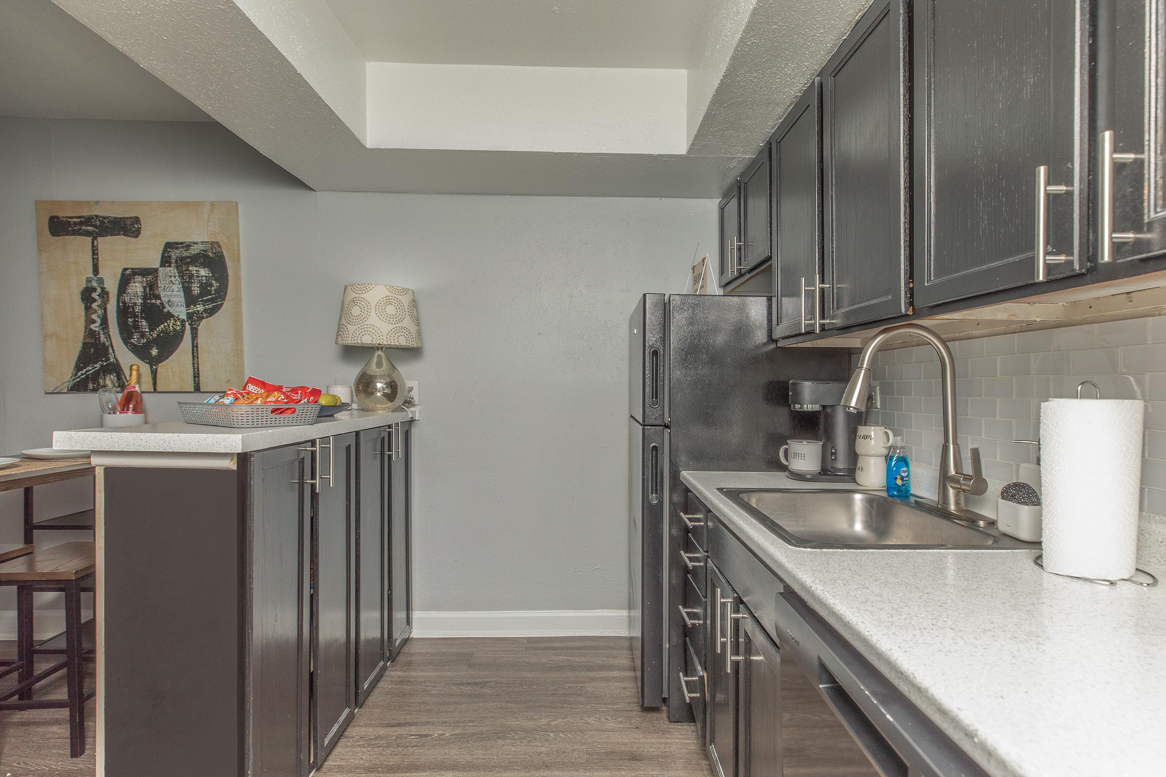 a kitchen with a sink and a refrigerator