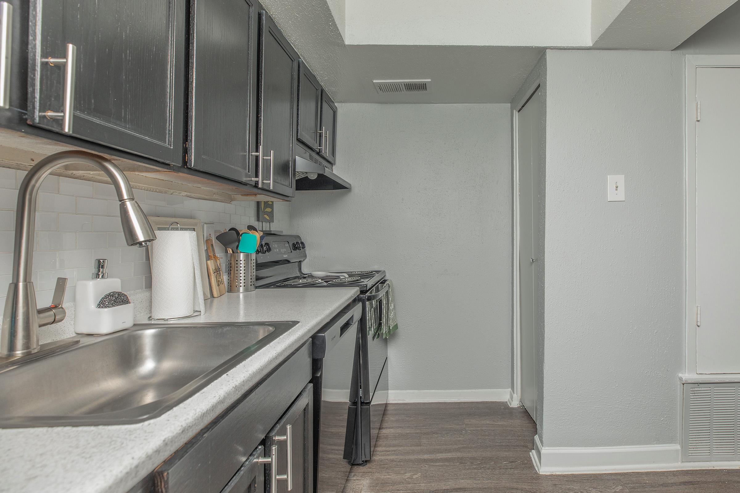 a kitchen with a stove and a sink