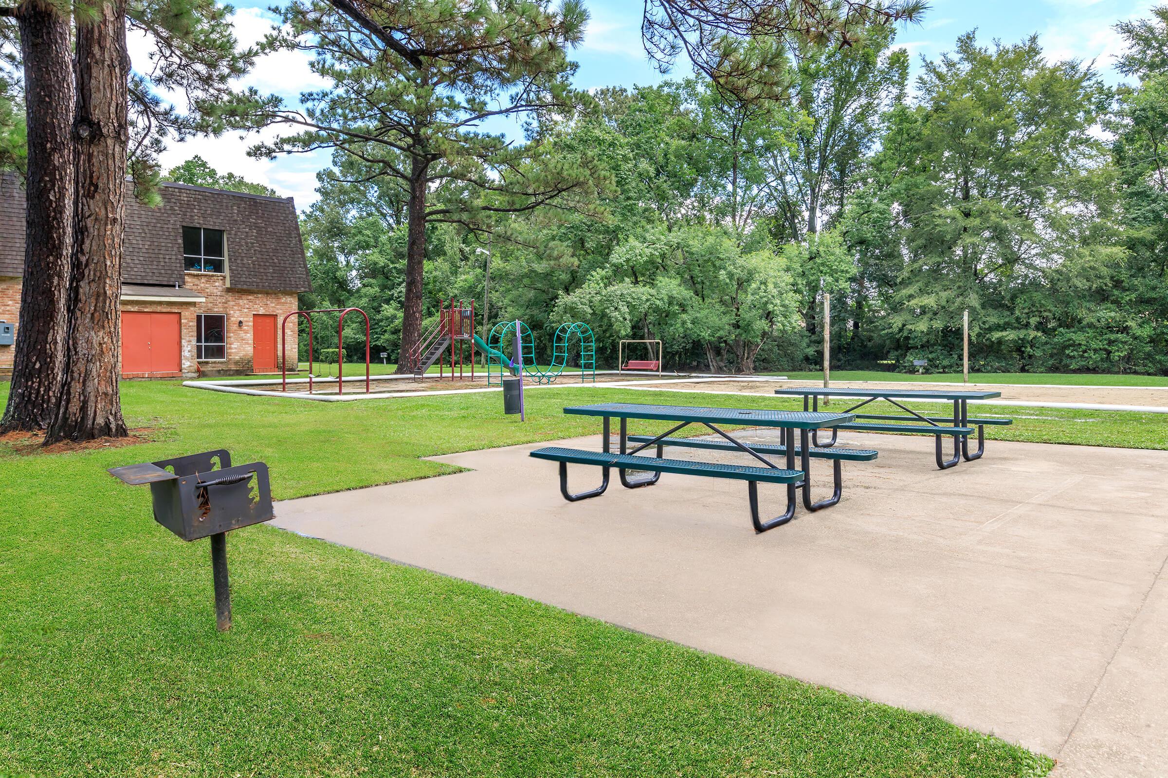 a group of lawn chairs sitting on top of a bench in a park