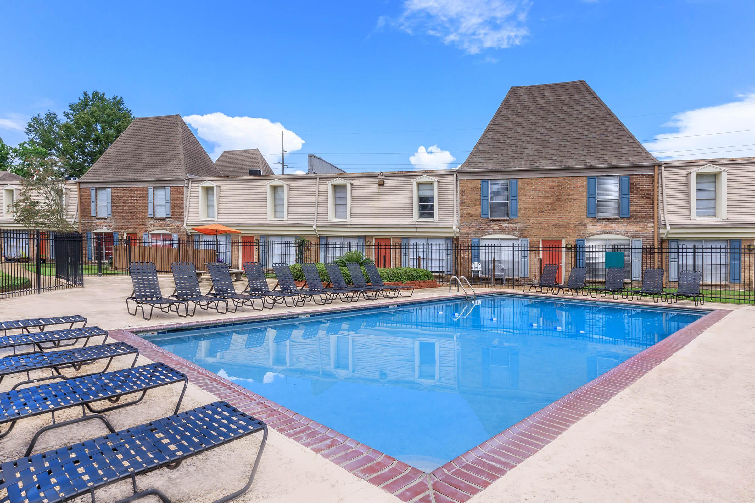 a house with a pool outside of a building