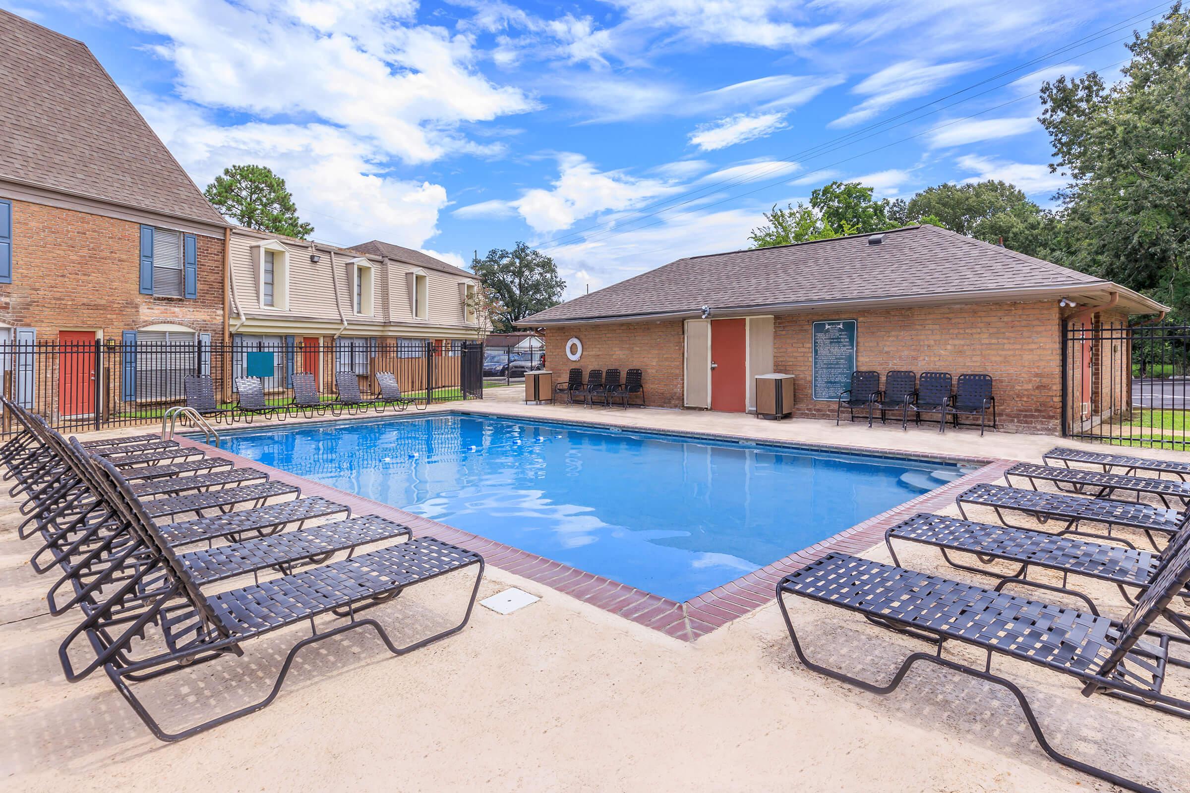 a house with a pool in front of a building