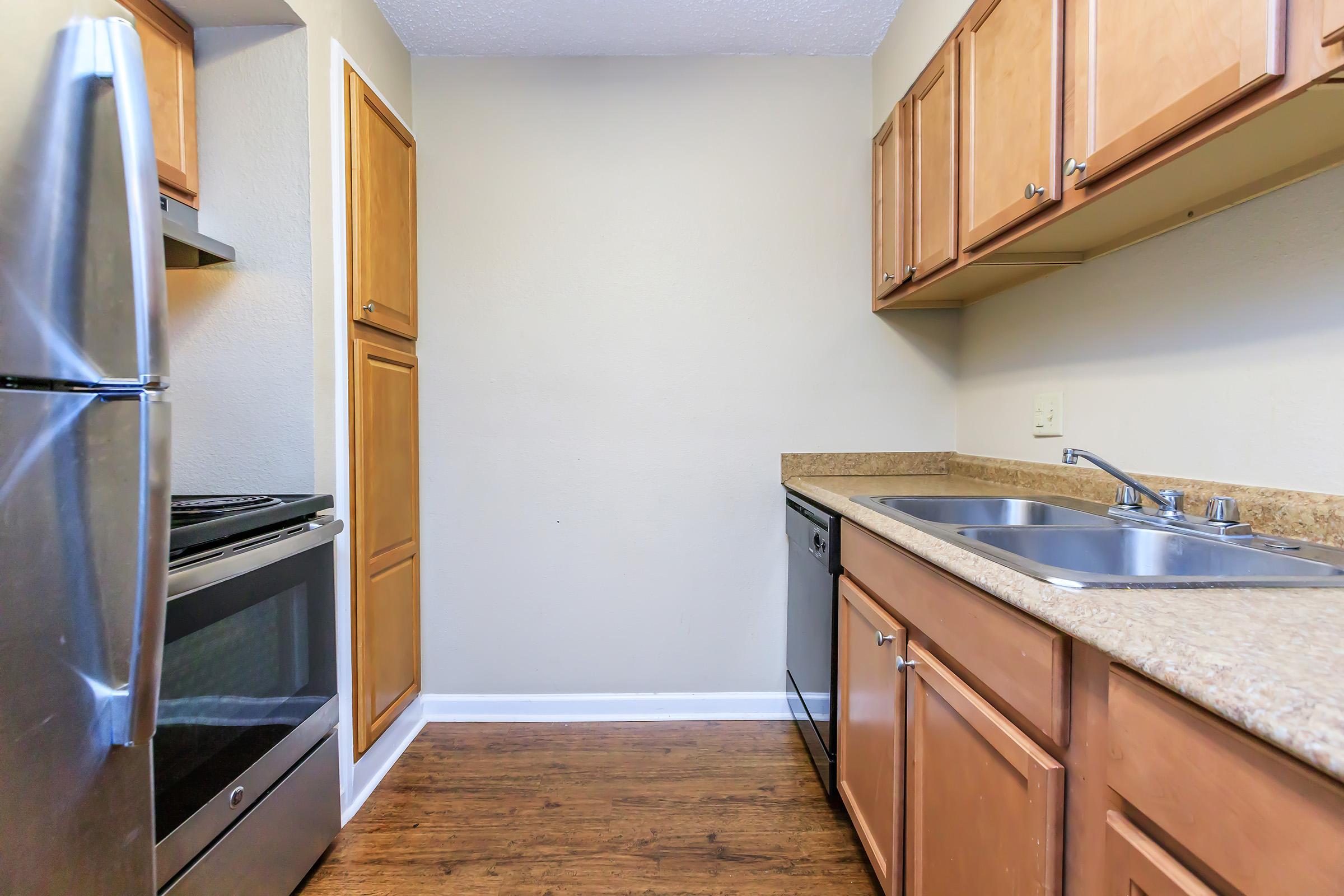 a kitchen with a stove sink and refrigerator