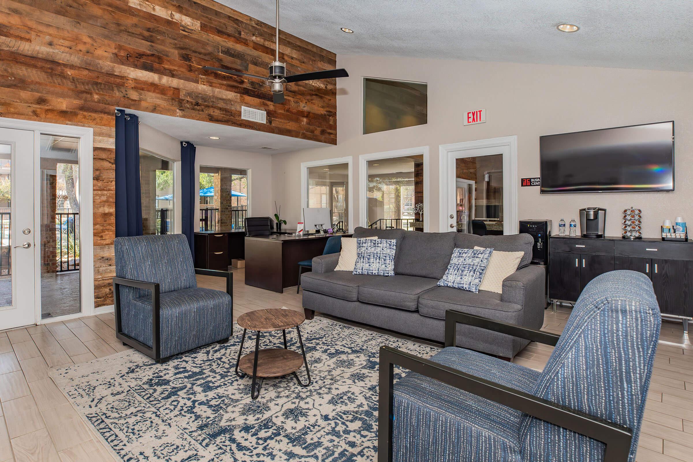 a living room filled with furniture and a large window