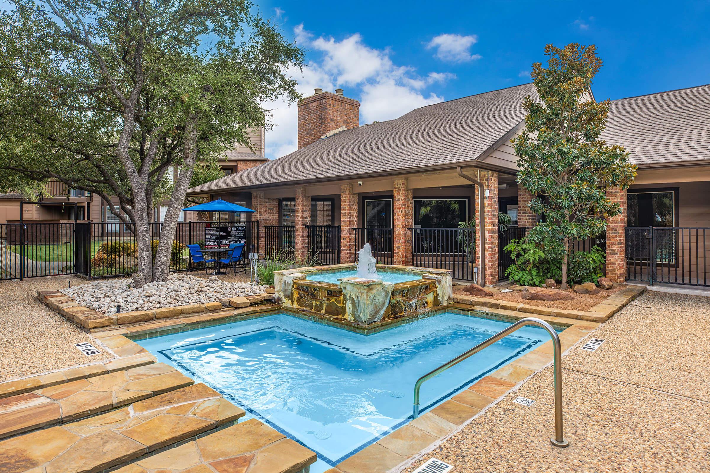 a house with a pool in front of a building