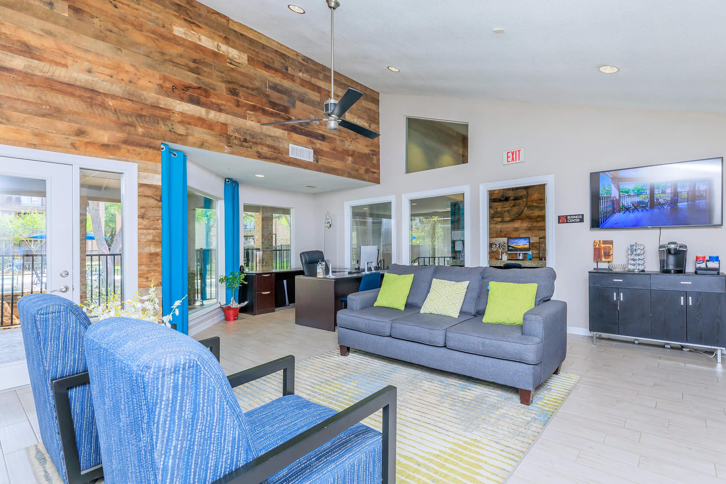 a living room filled with furniture and a flat screen tv