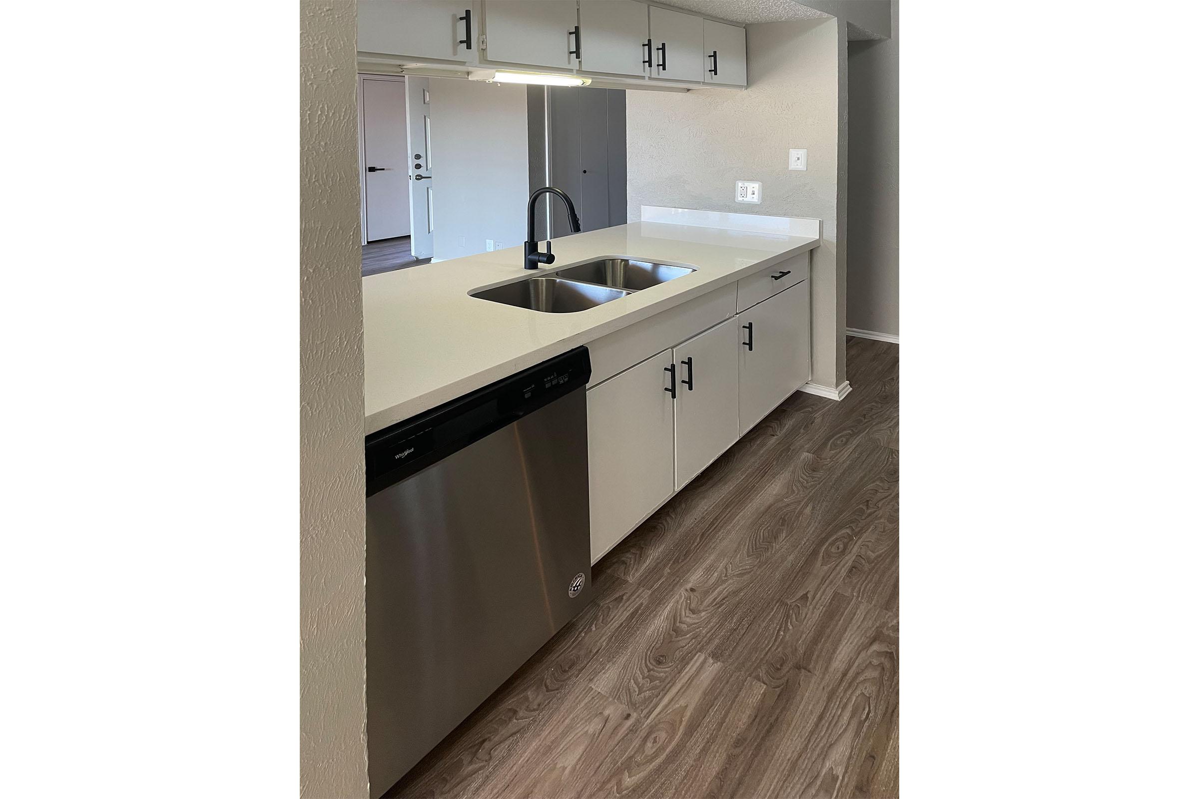 a kitchen with a sink and a mirror