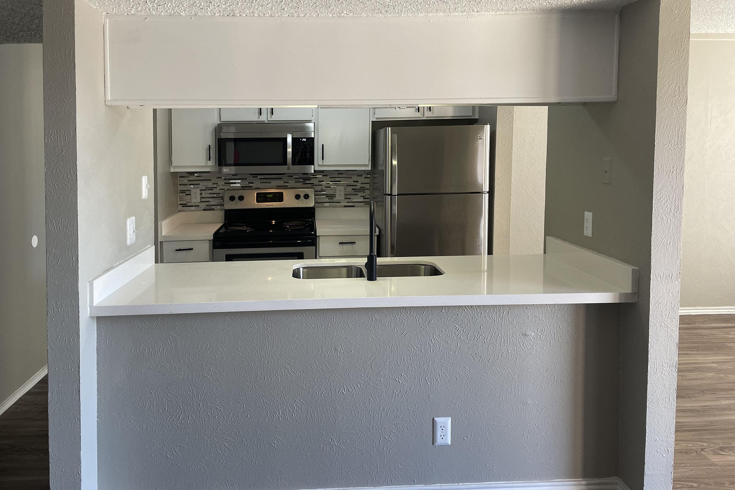 a microwave oven sitting on top of a refrigerator