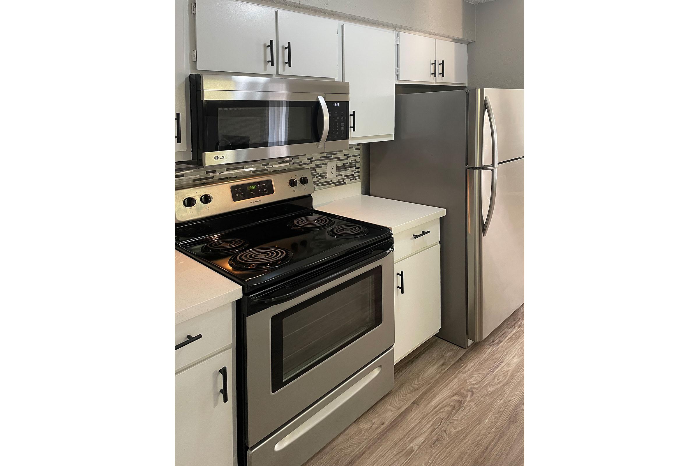 a stove top oven sitting inside of a kitchen