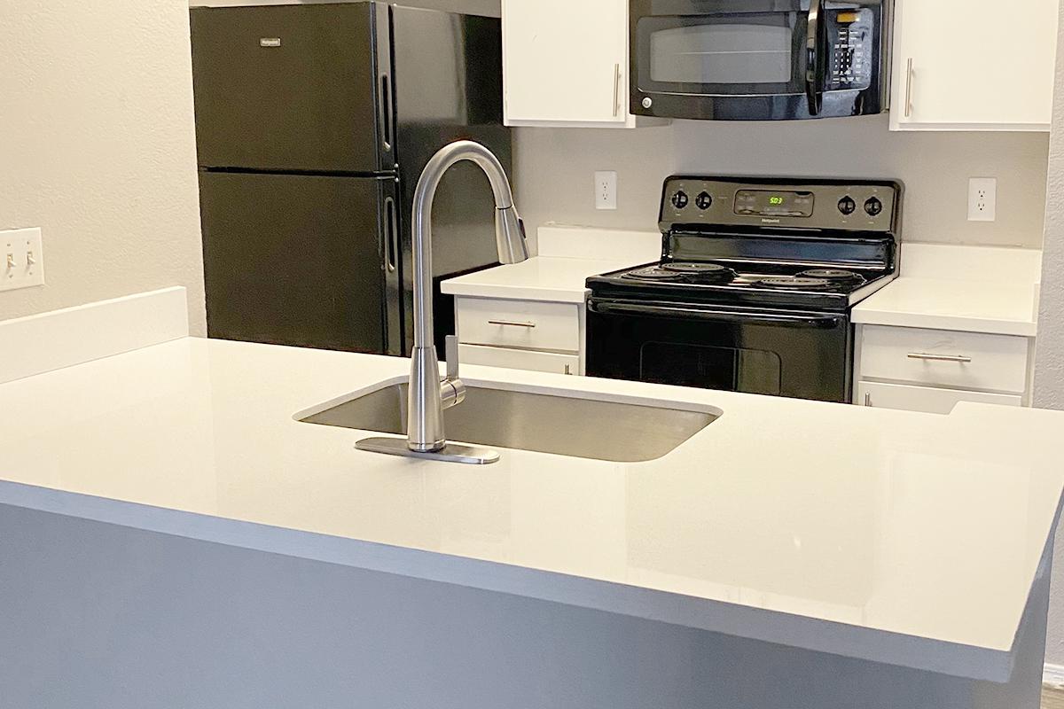 a kitchen with a sink and a microwave