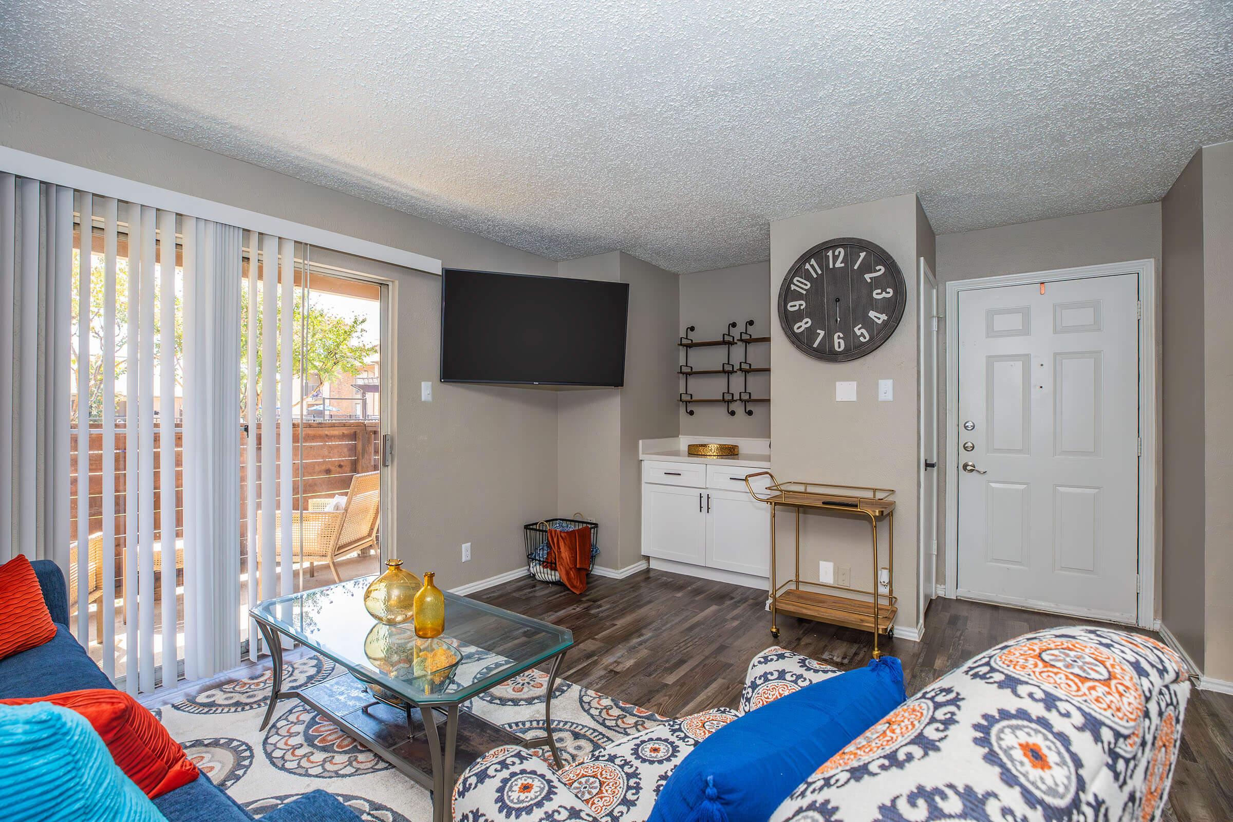 a living room filled with furniture and a large window