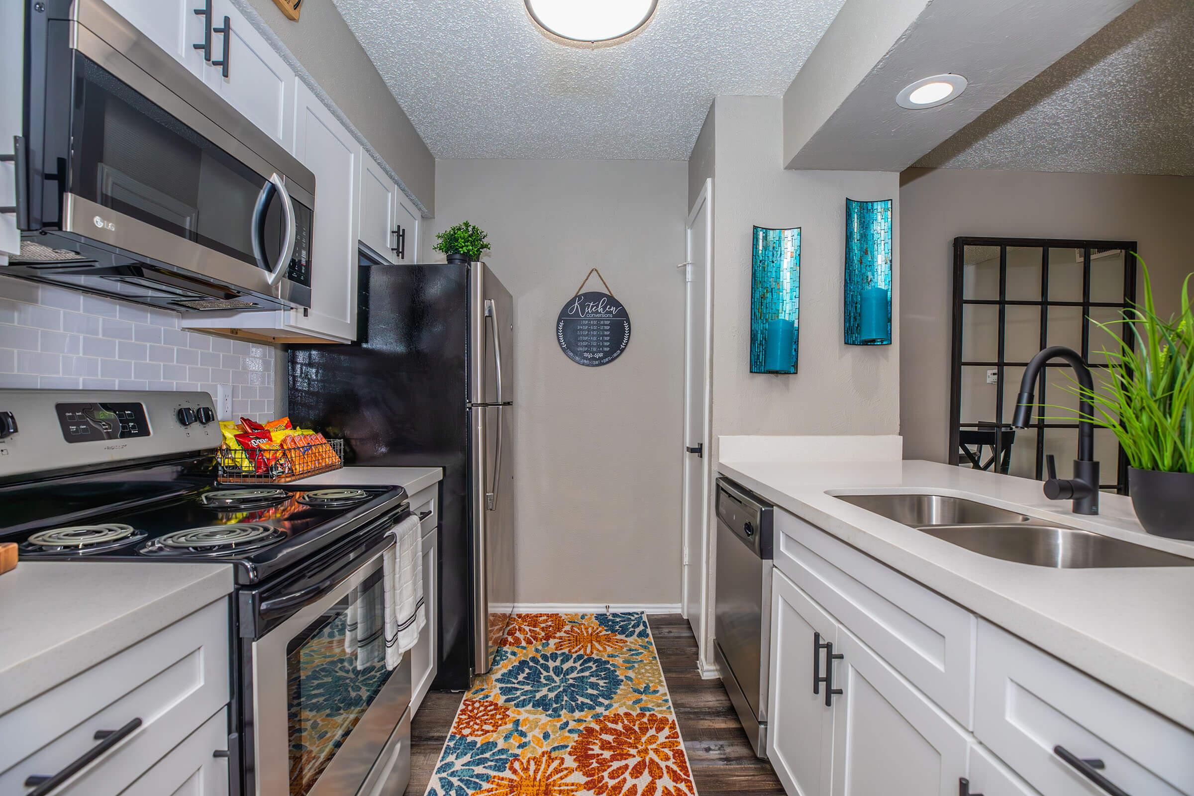 a stove top oven sitting inside of a kitchen