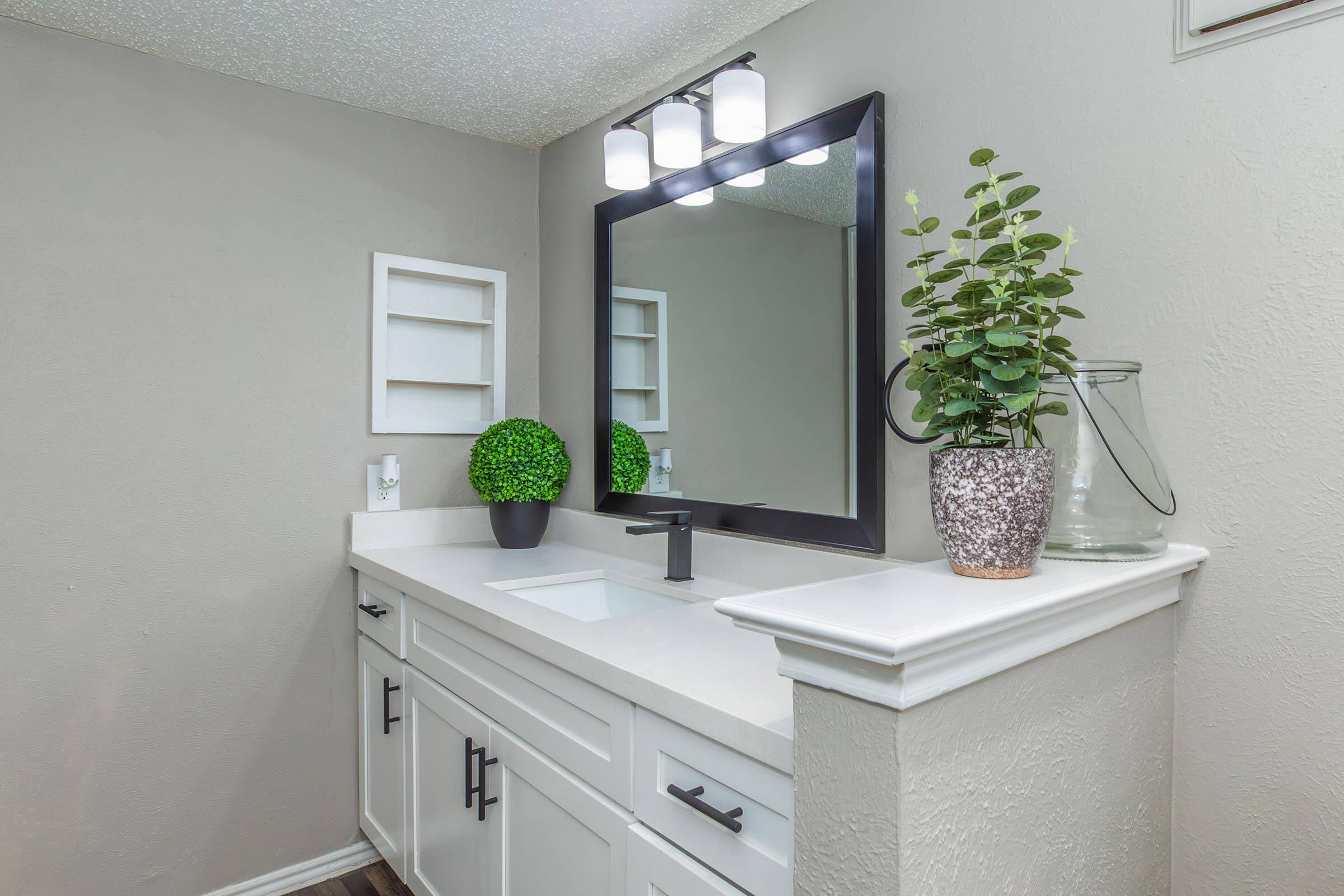 a kitchen with a sink and a mirror