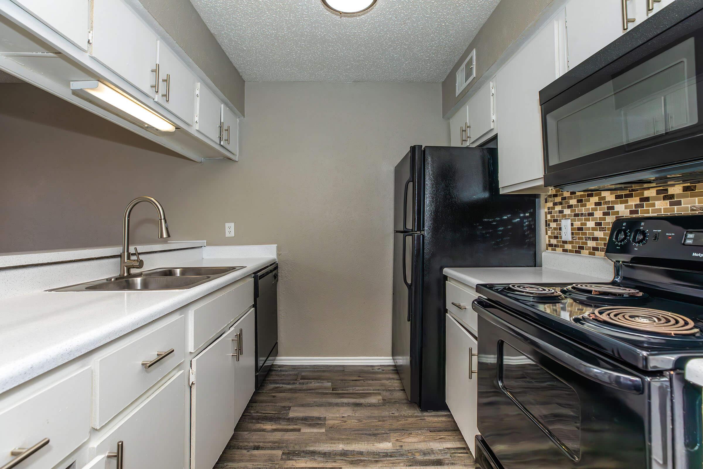 a stove top oven sitting inside of a kitchen