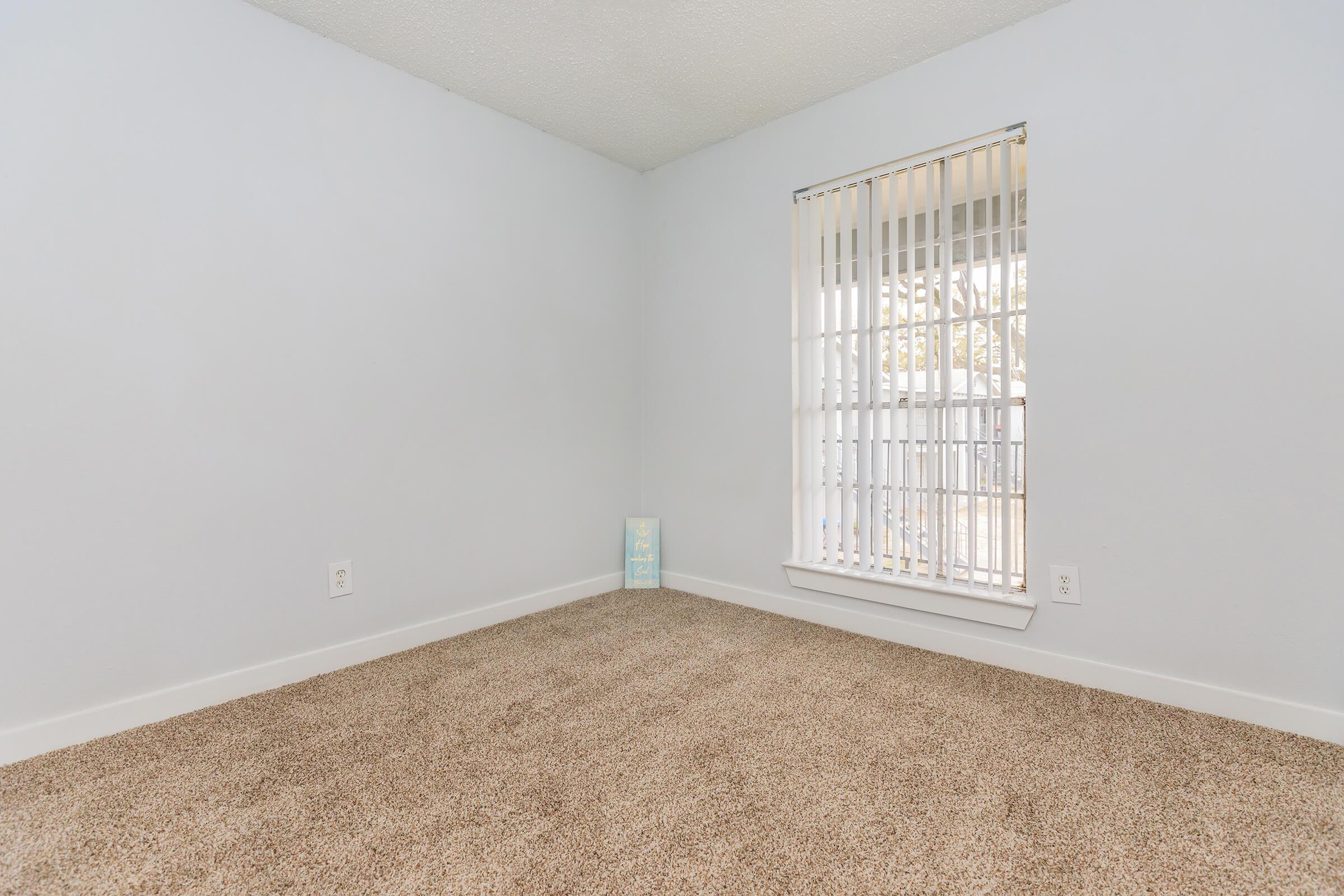 a bedroom with a large window