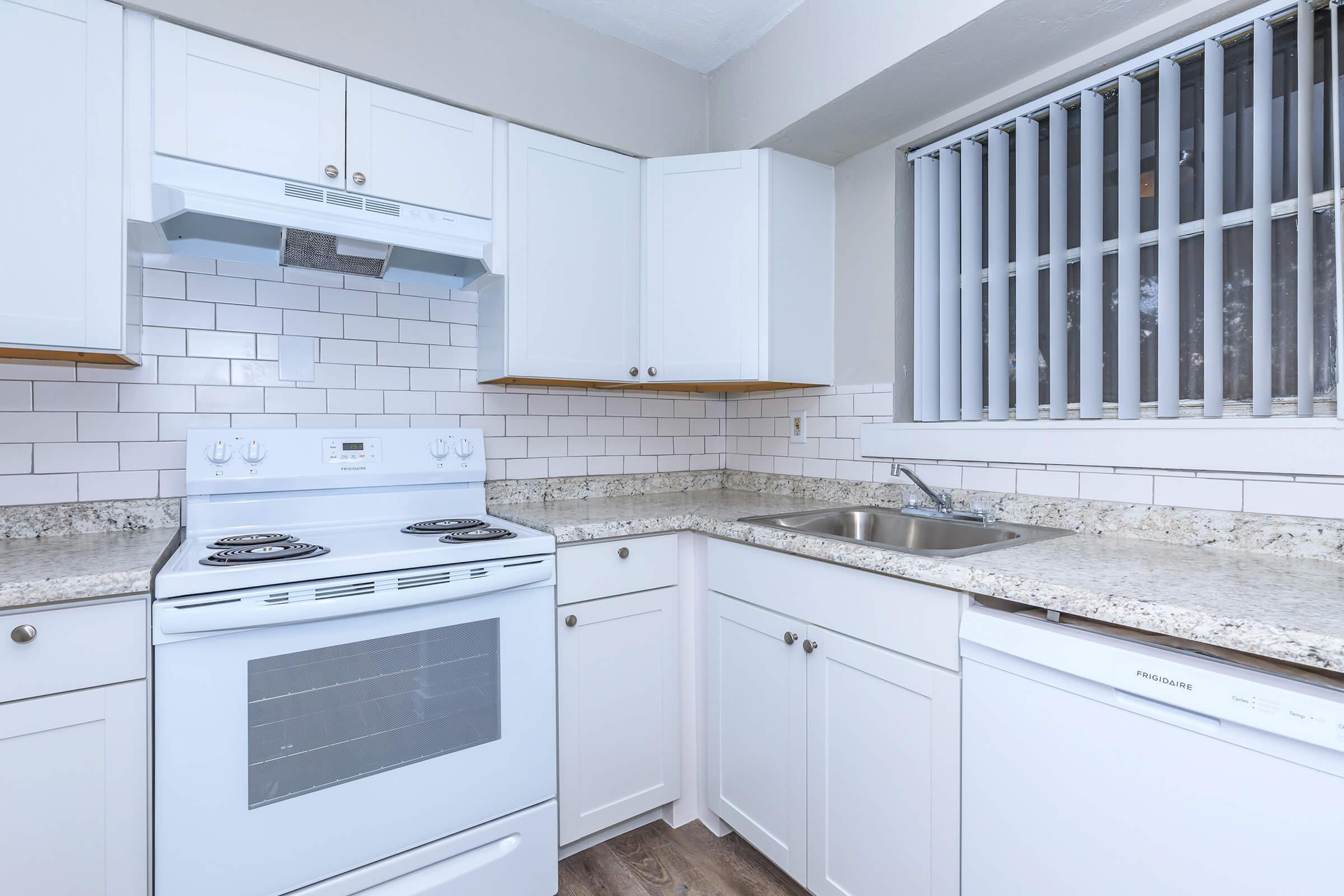 a white stove top oven sitting inside of a kitchen