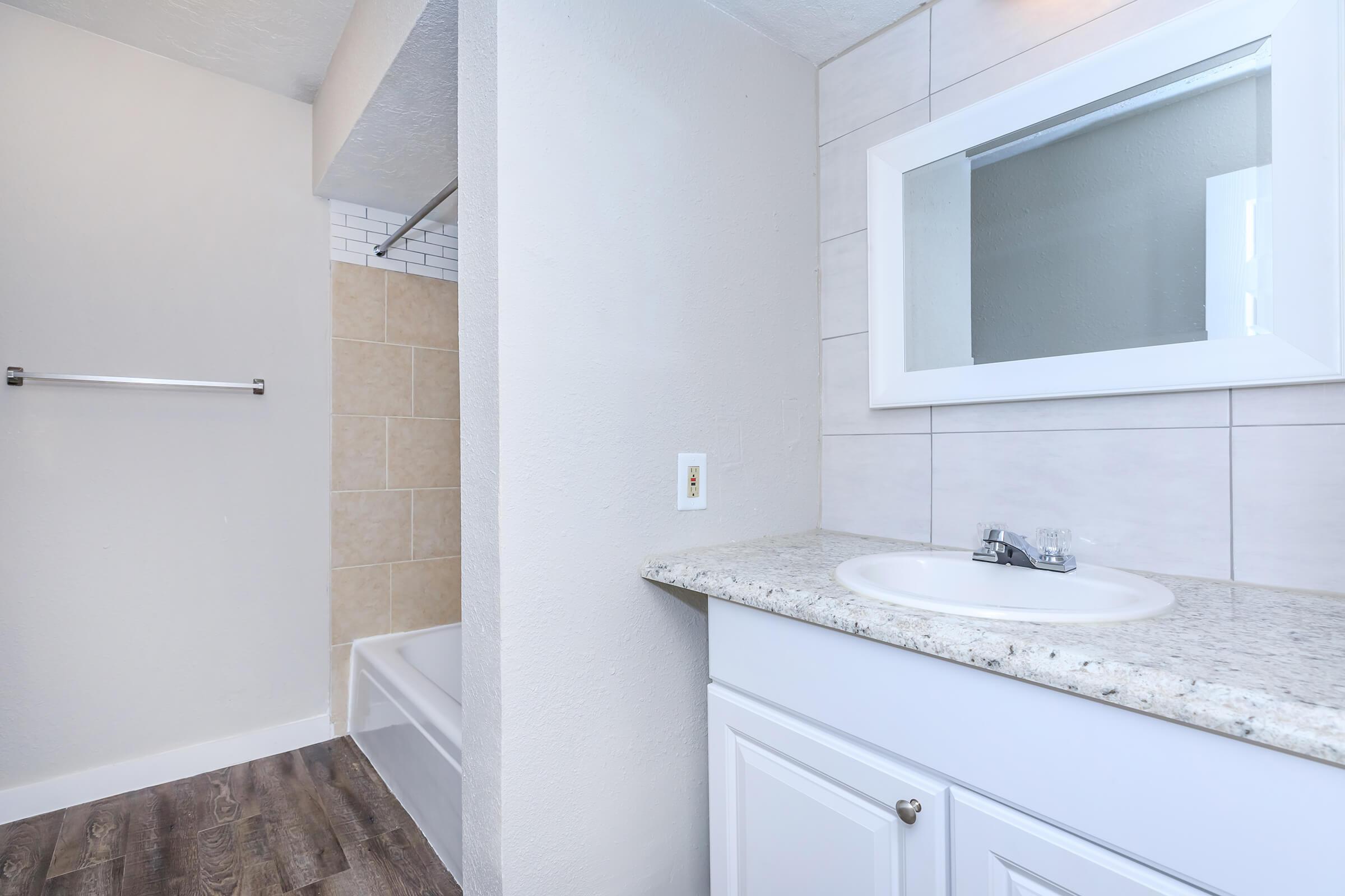 a white sink sitting under a window