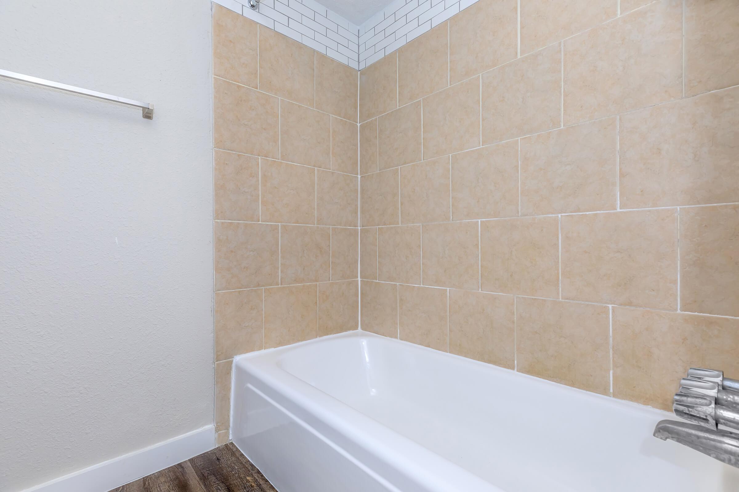 a large white tub sitting next to a sink