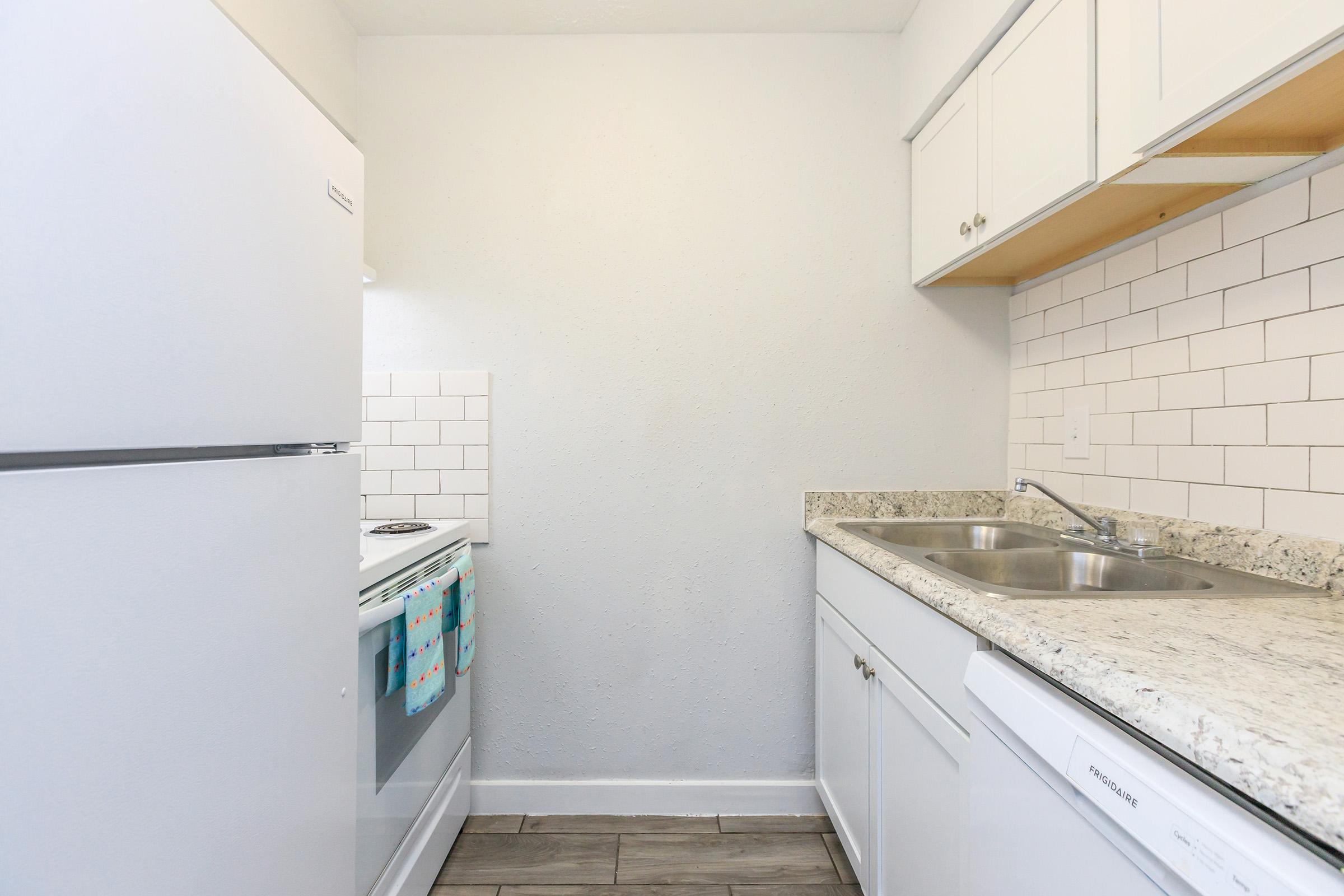 a kitchen with a sink and a refrigerator