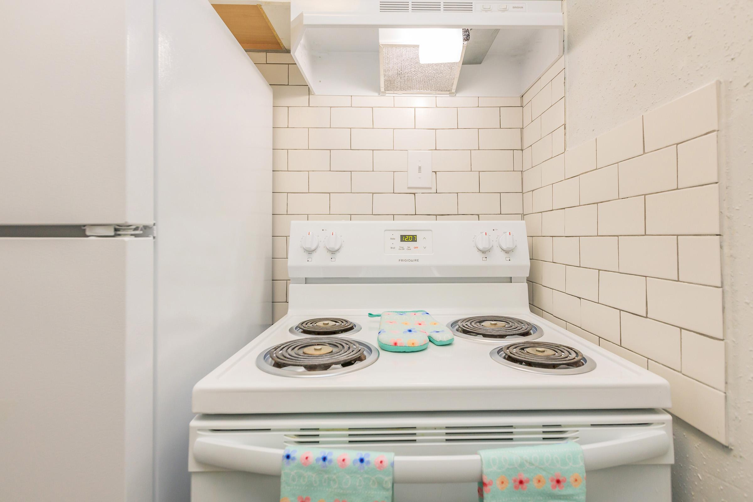 a stove top oven sitting inside of a refrigerator