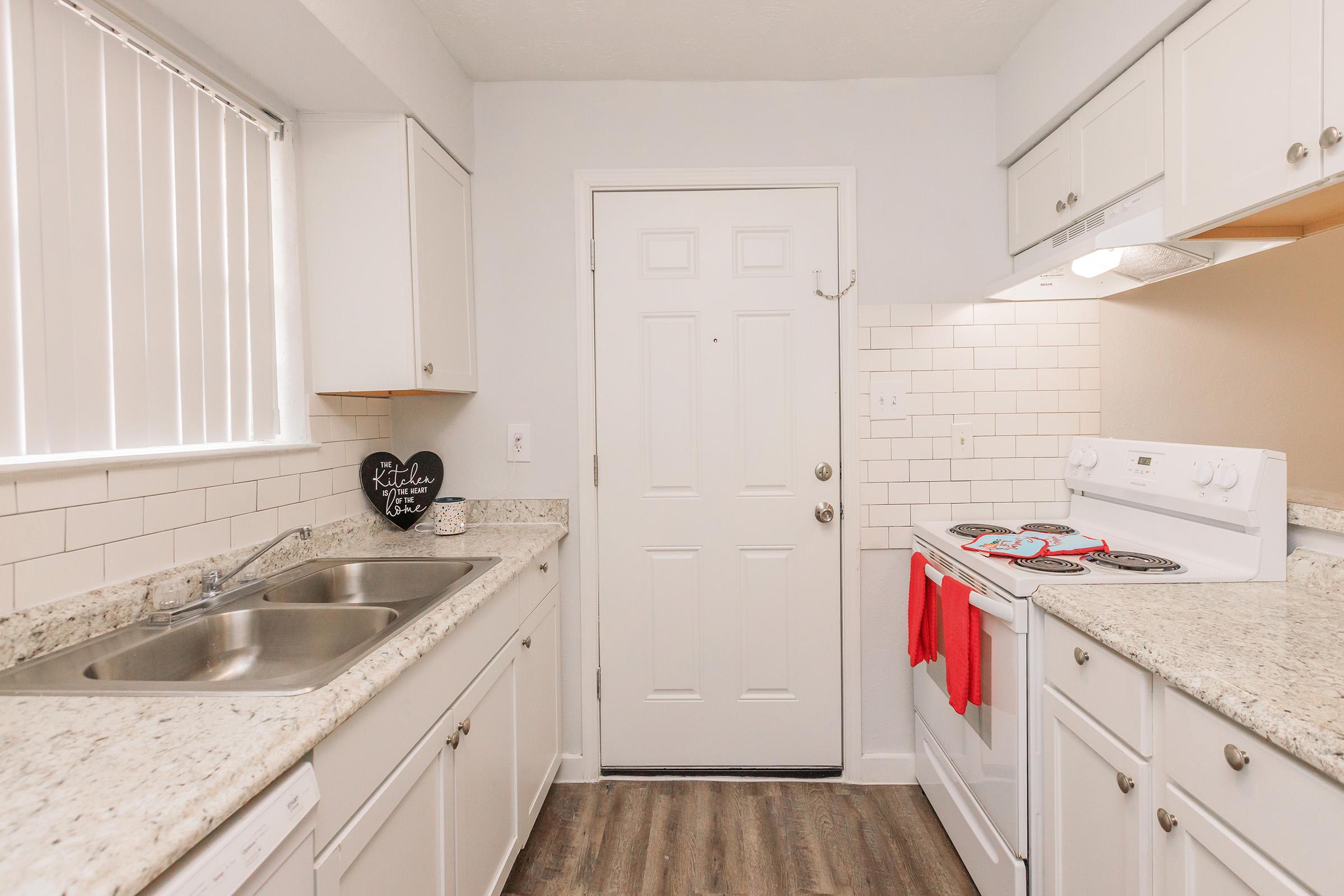 a kitchen with a stove and a sink