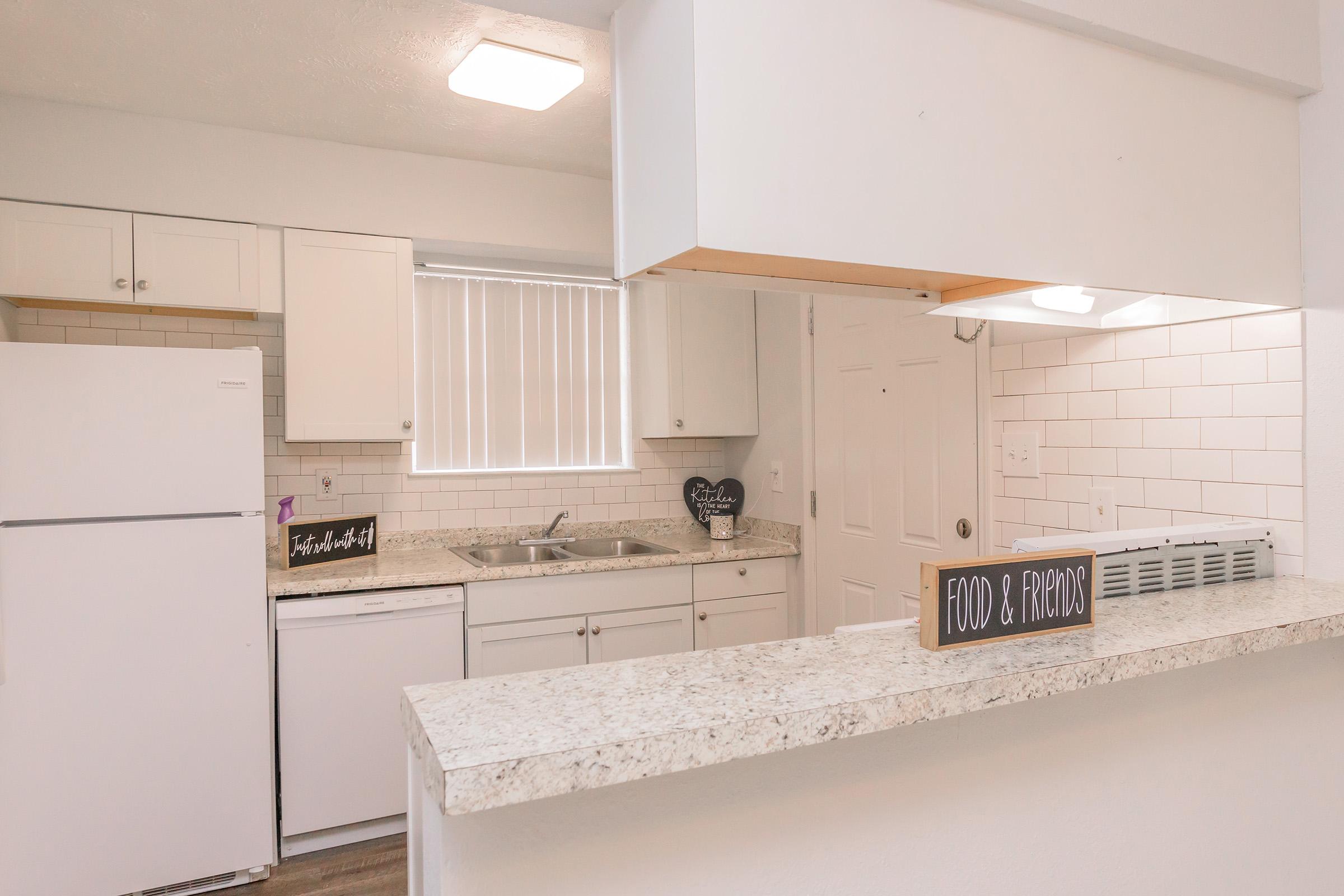 a kitchen with a stove and a refrigerator